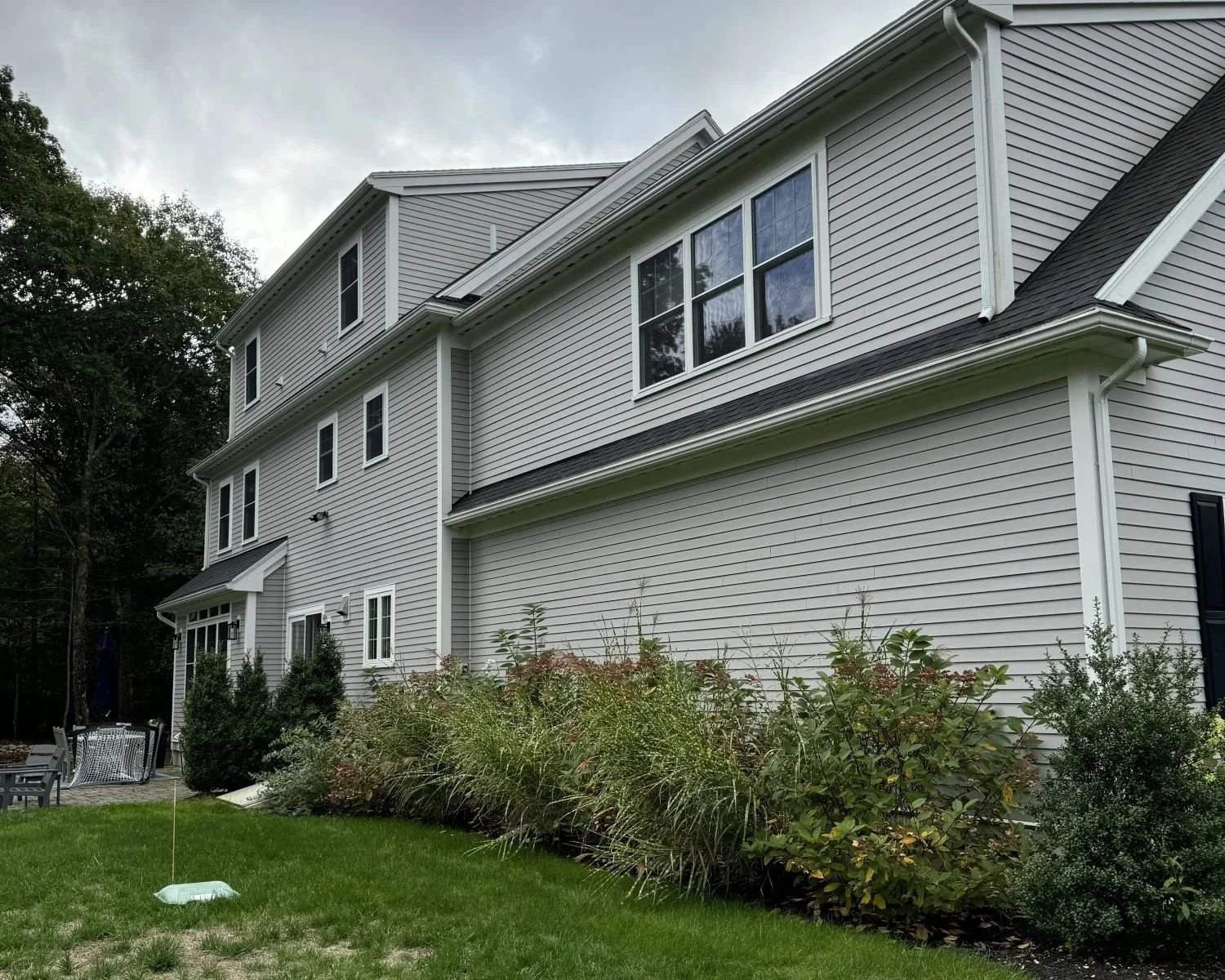 Existing rear of large colonial home in Hamilton, MA illustrating an undifferentiated facade prior to renovation.