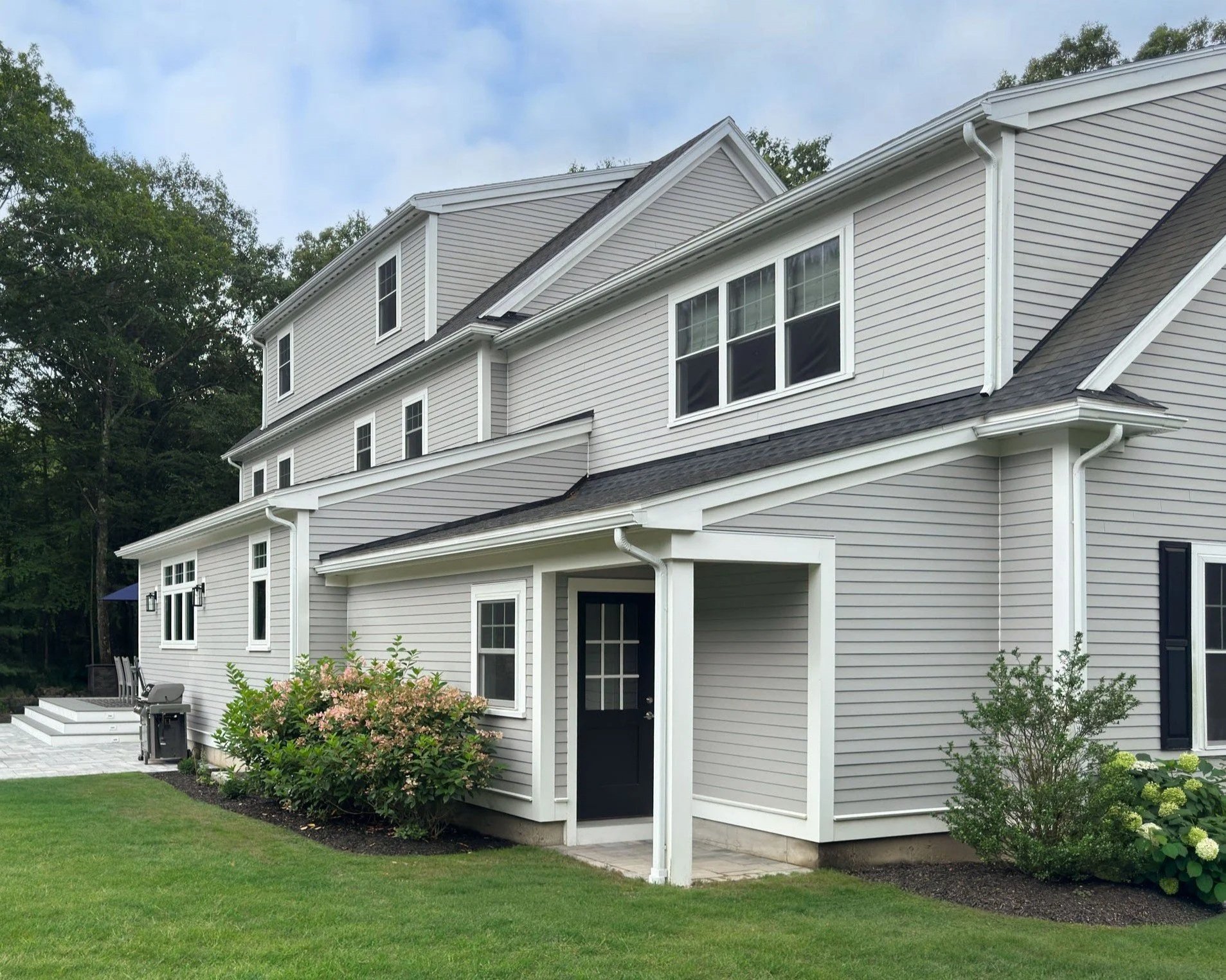 A new addition to large North Shore colonial home that features a rear entrance with full stair to basement and kitchen addition with deck.