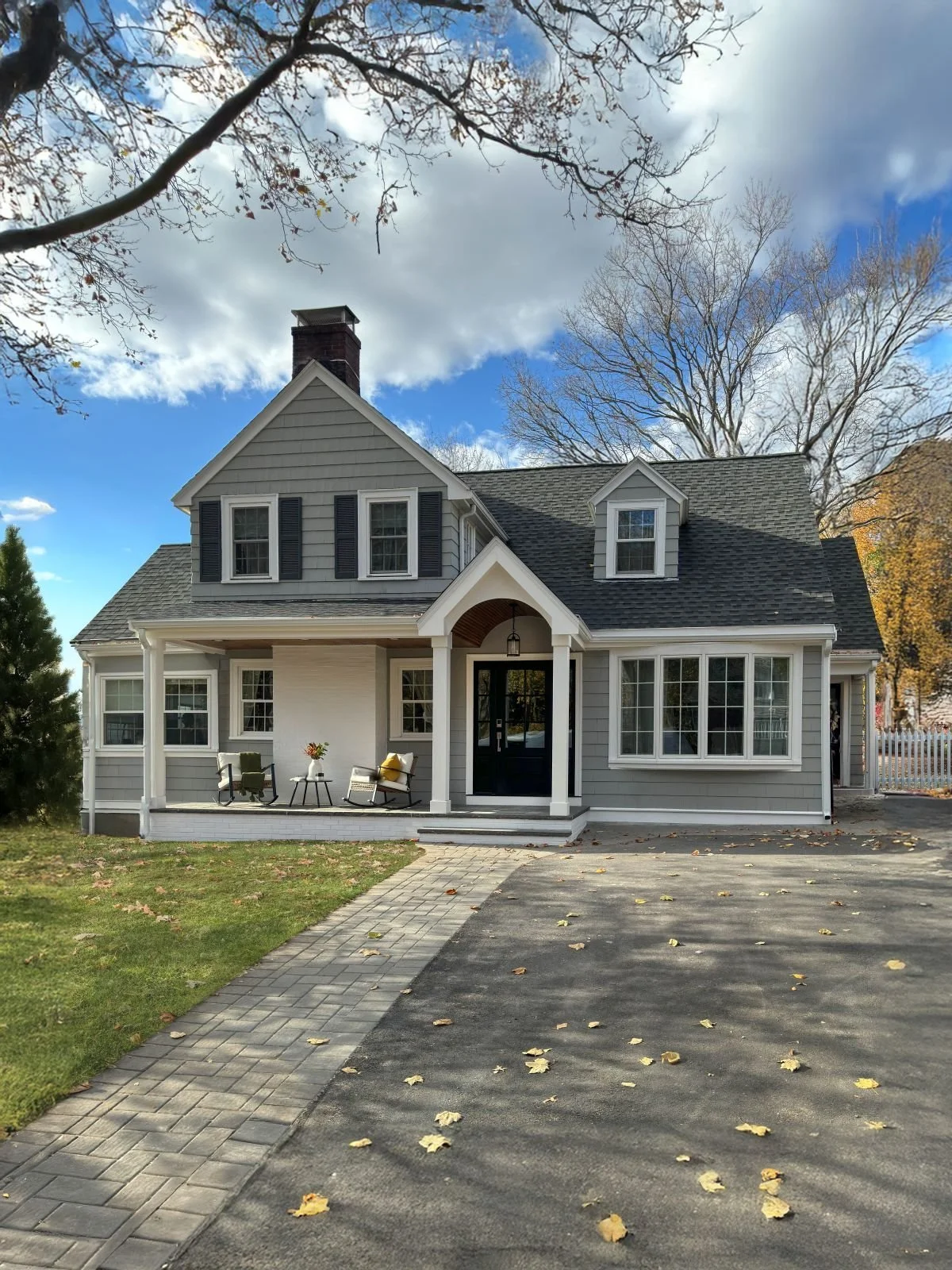 Exterior view of a custom covered porch addition in Melrose, MA, illustrating how the new structure creates clear architectural hierarchy and connects the home's existing geometric forms.