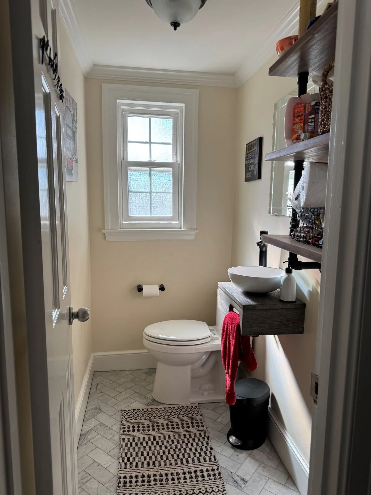 Small bathroom with vessel sink and wall mounted shelving