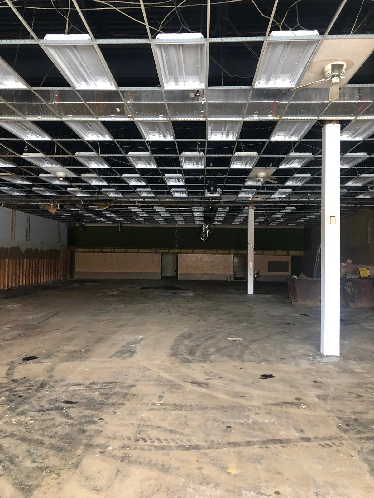 existing interior of retail warehouse with slab floor and ceiling grid