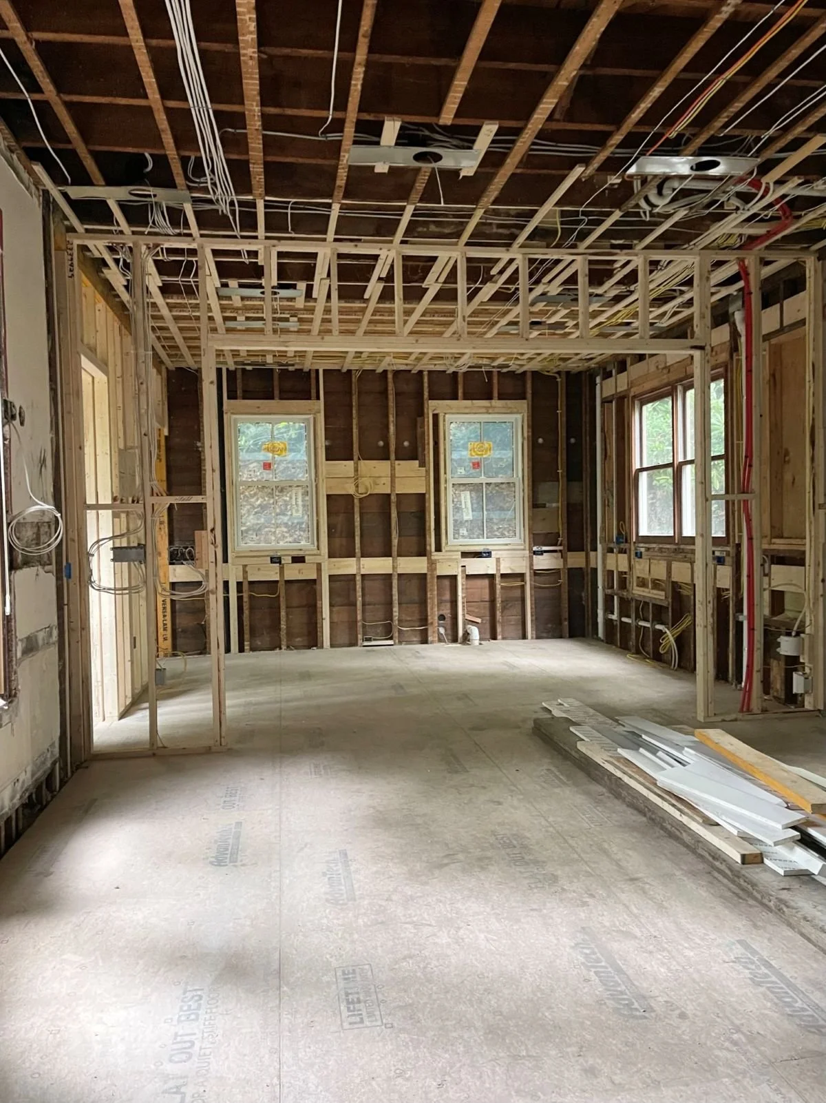 The rough-in phase of construction, showing the coordination of electrical and plumbing systems within the new architectural layout.