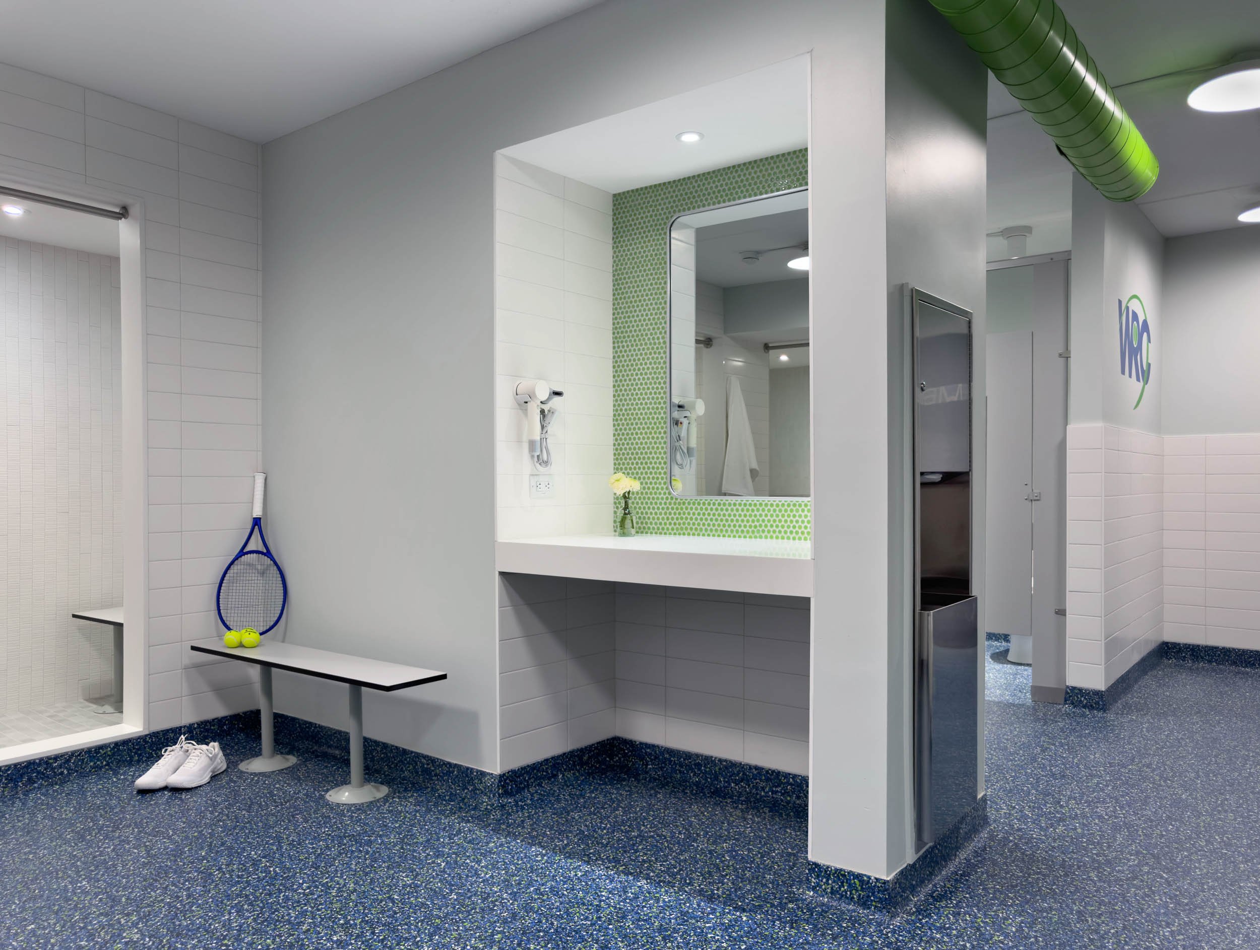 hair drying and vanity station with bench seating in women's locker room