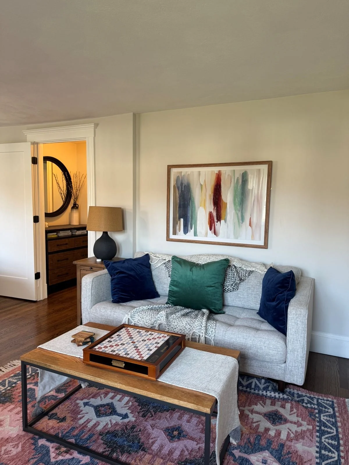 Existing ground level primary sitting area of a Dutch Colonial home in Greater Boston prior to second story addition showing original layout before renovation by Tact and Grit Design Co.