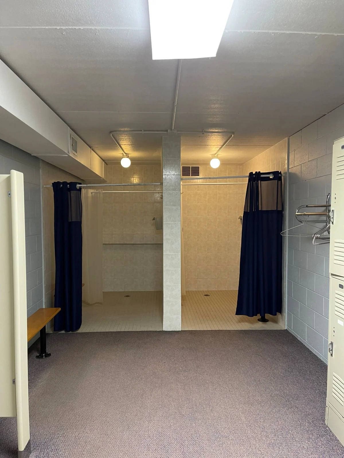 Existing Women's showers prior to locker room renovation at Woburn Racquet Club