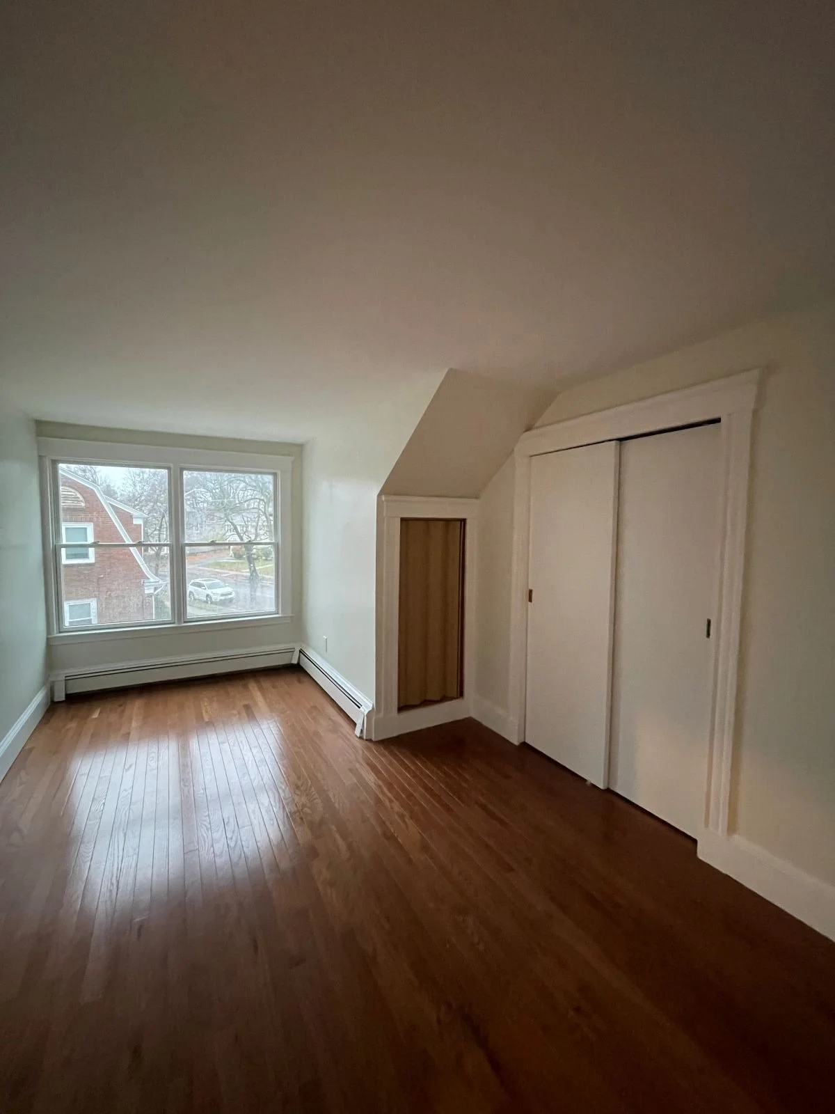 empty bedroom prior to conversion to primary bathroom in Medford, MA