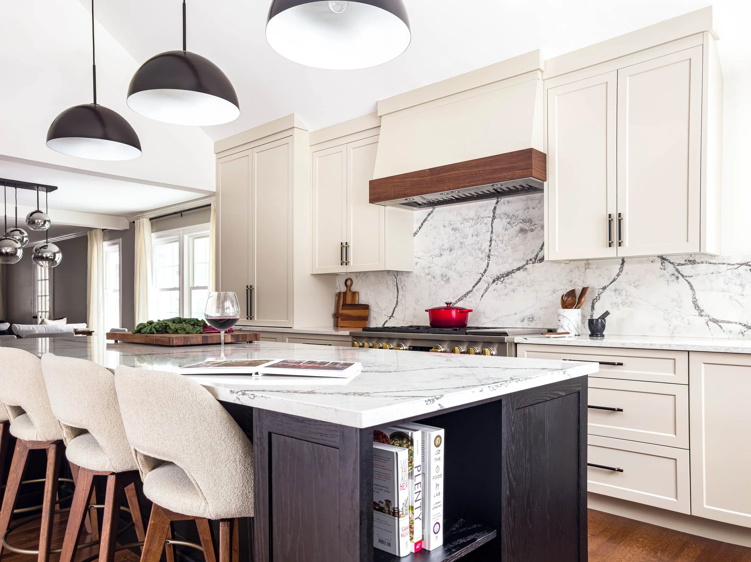 Close-up of a 10-foot black stained solid oak island featuring integrated open shelving for cookbook storage, highlighting the natural wood grain.
