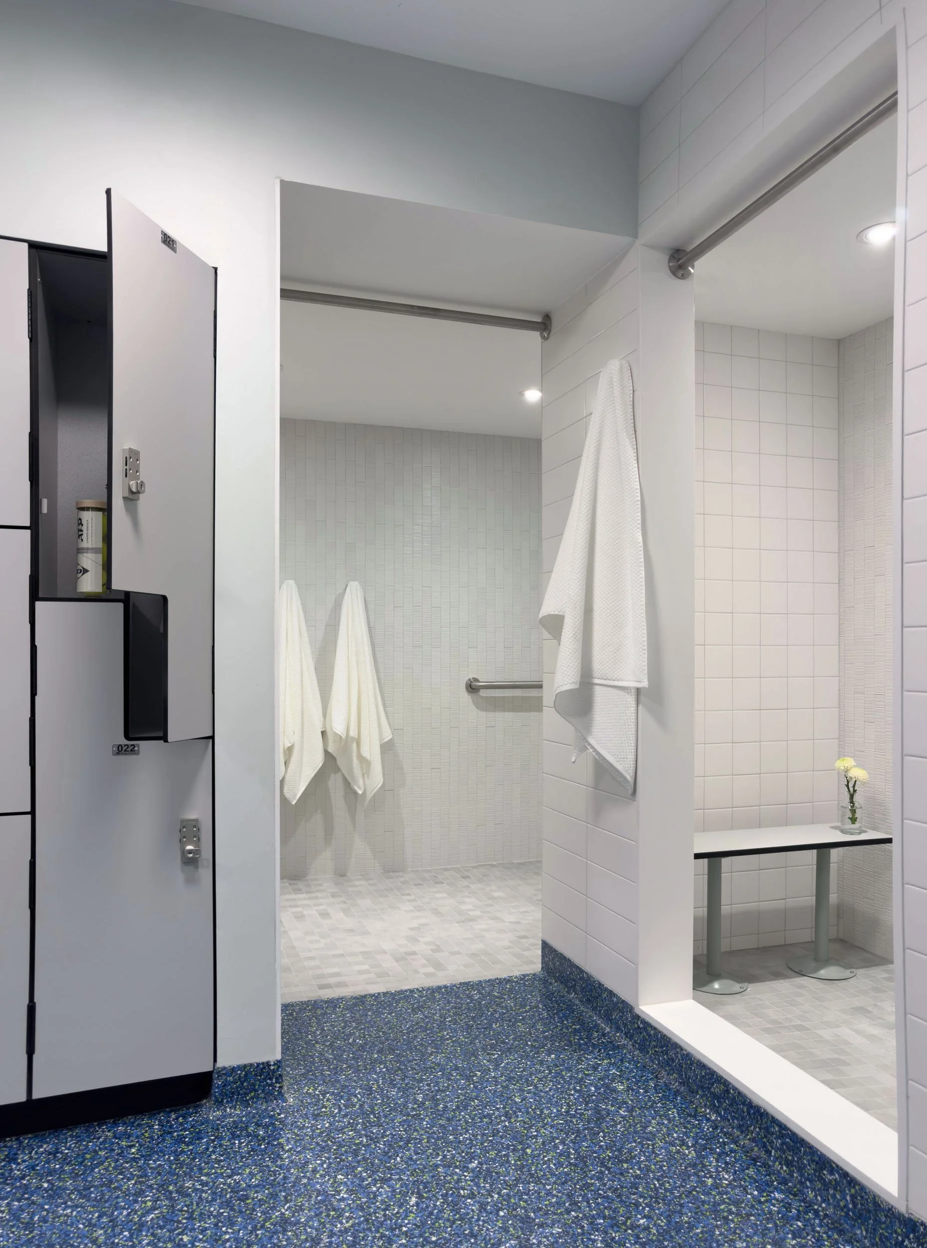 accessible shower entry from locker room changing area with epoxy floor flush with wet room tile  