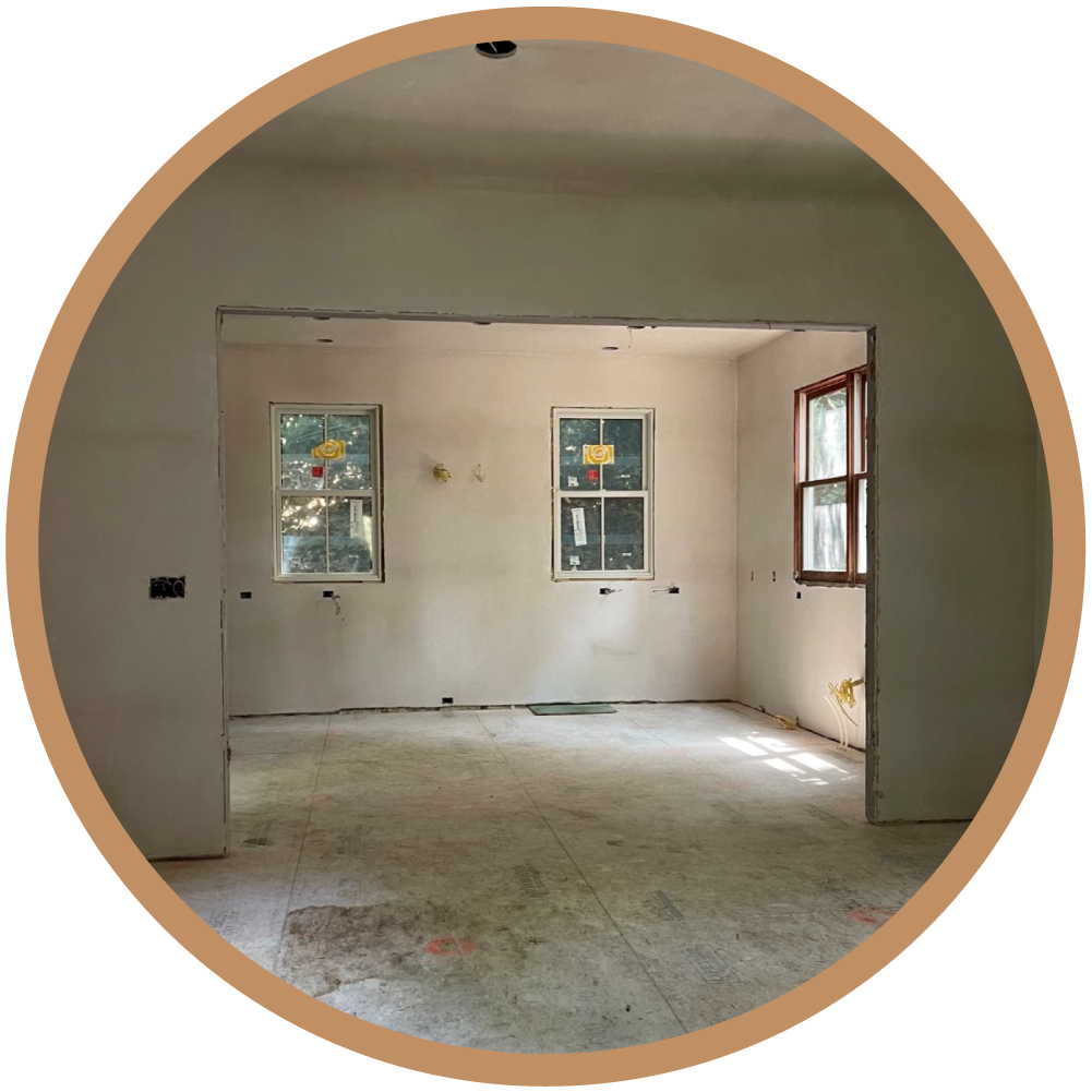 New interior walls following board and plaster installation, defining the reimagined spatial volume of the home.