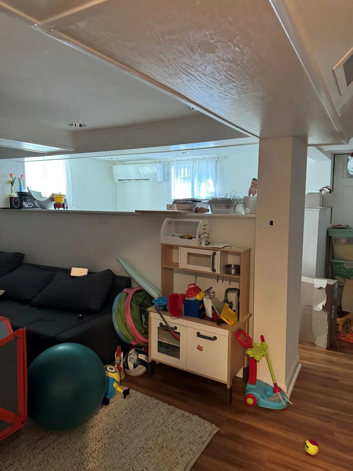 Basement playroom before addition and new LVL installation to raise drop beams