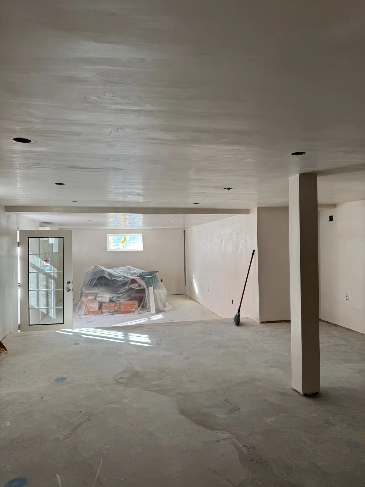 Open light filled basement with new addition and stair to grade