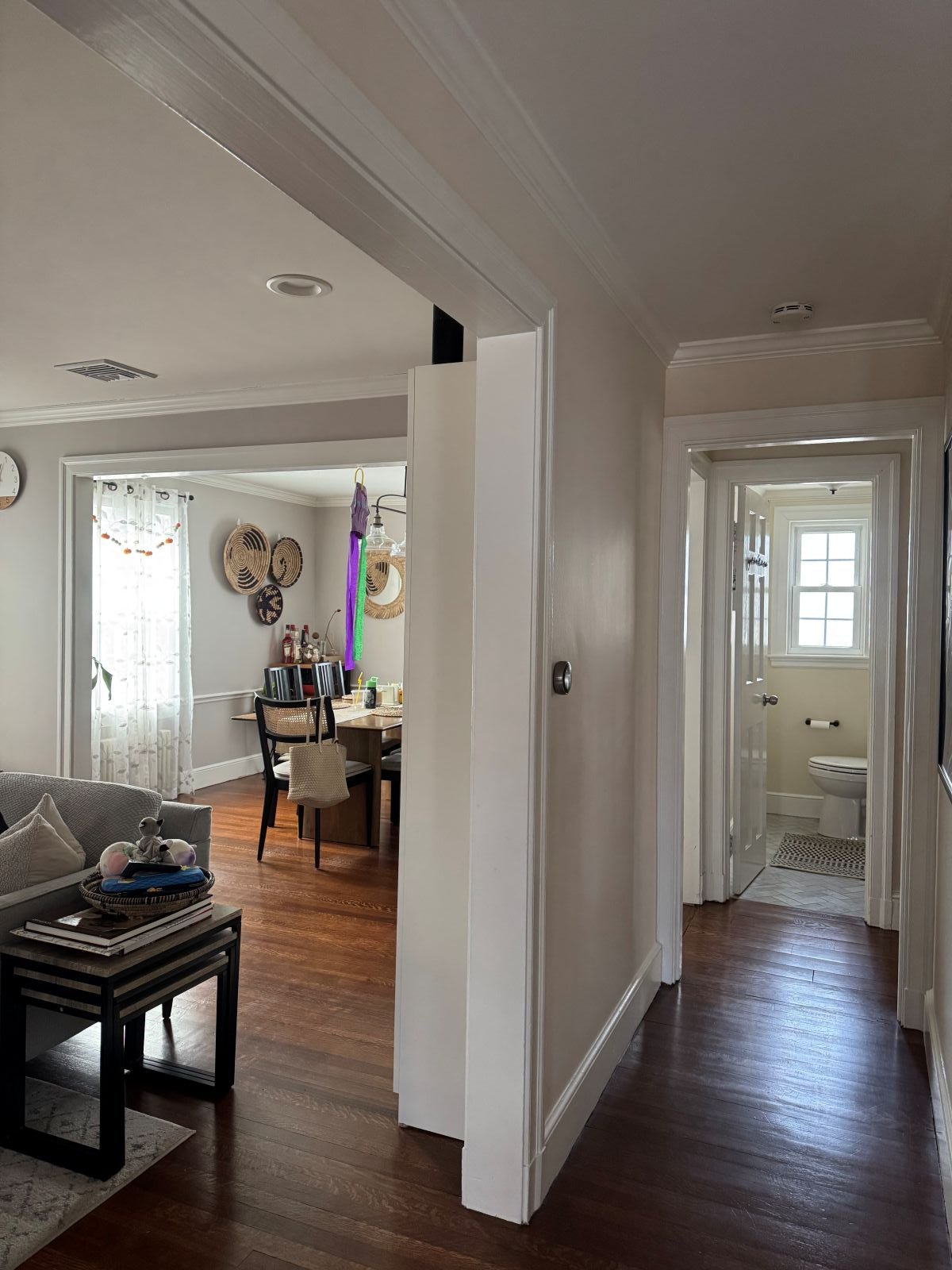 Interior view of a compartmentalized 1939 home in Melrose, MA, showing narrow doorways and dark living spaces prior to an open-concept architectural renovation.
