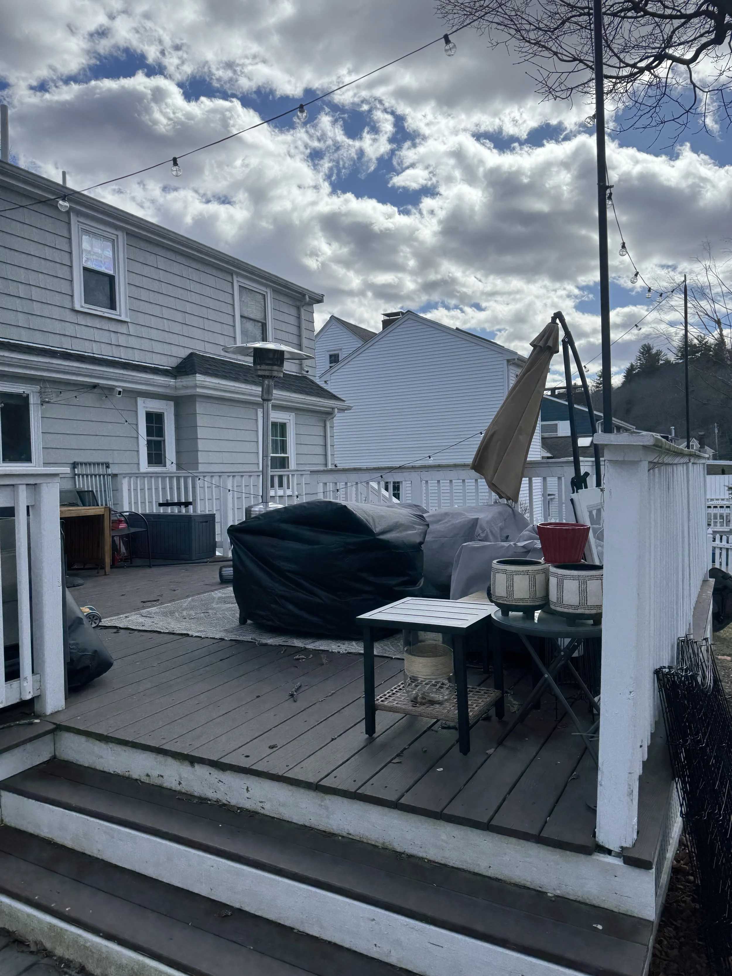 Existing deck and outdoor living area of a colonial home in Melrose, MA prior to rear addition and renovation by Tact and Grit Design Co.