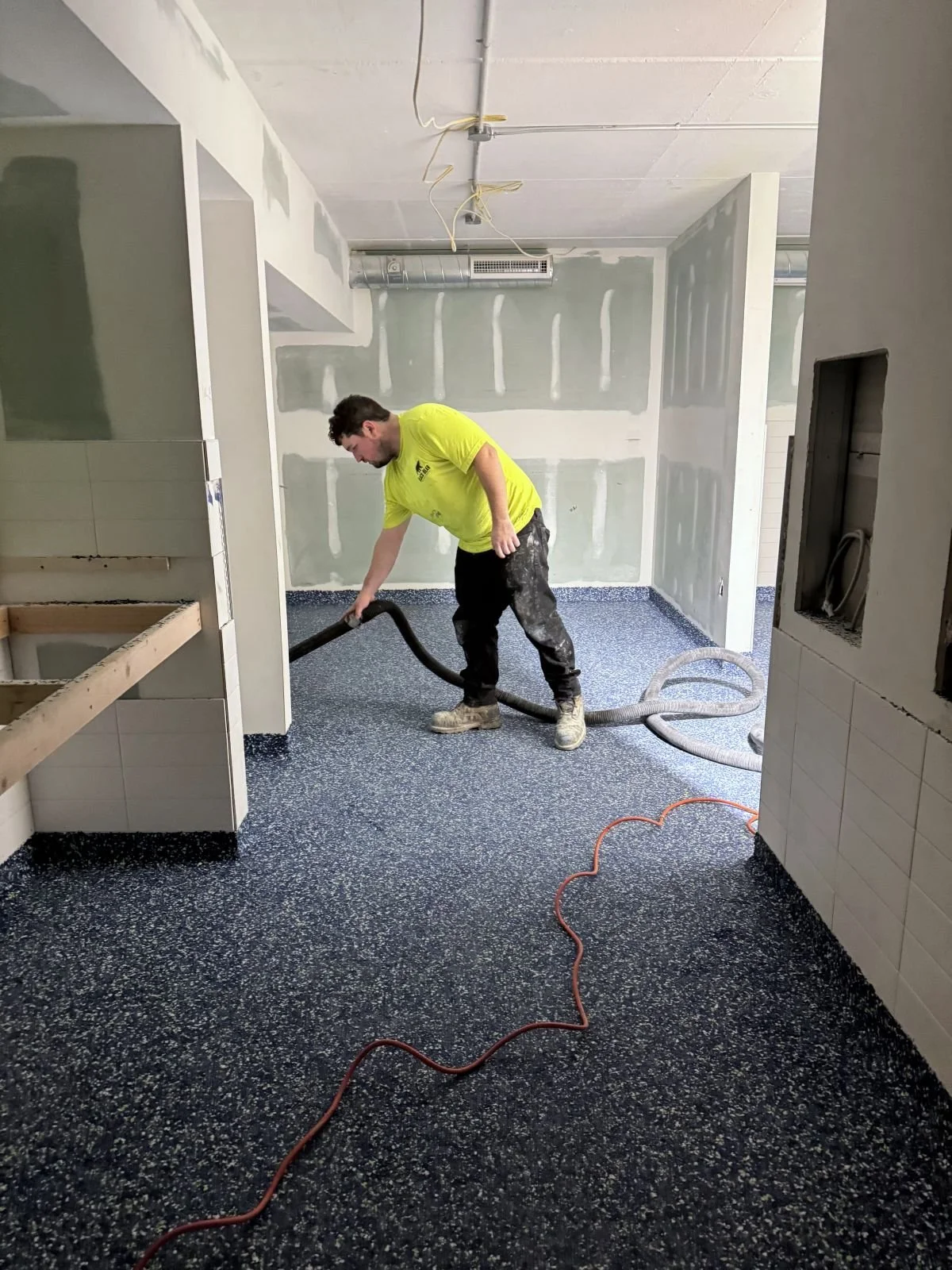 Epoxy floor installation with custom brand colors for Woburn Racquet Club