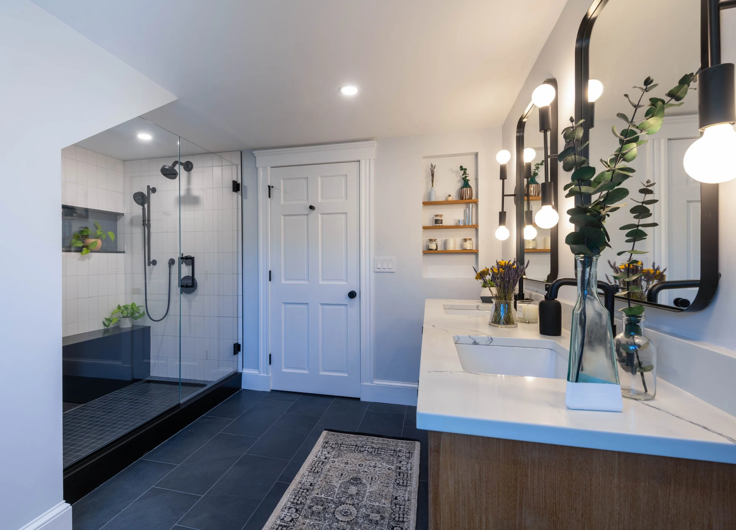 A modern primary bathroom in Medford, MA, elegantly converted from a former fourth bedroom to create a cohesive and spacious primary suite.