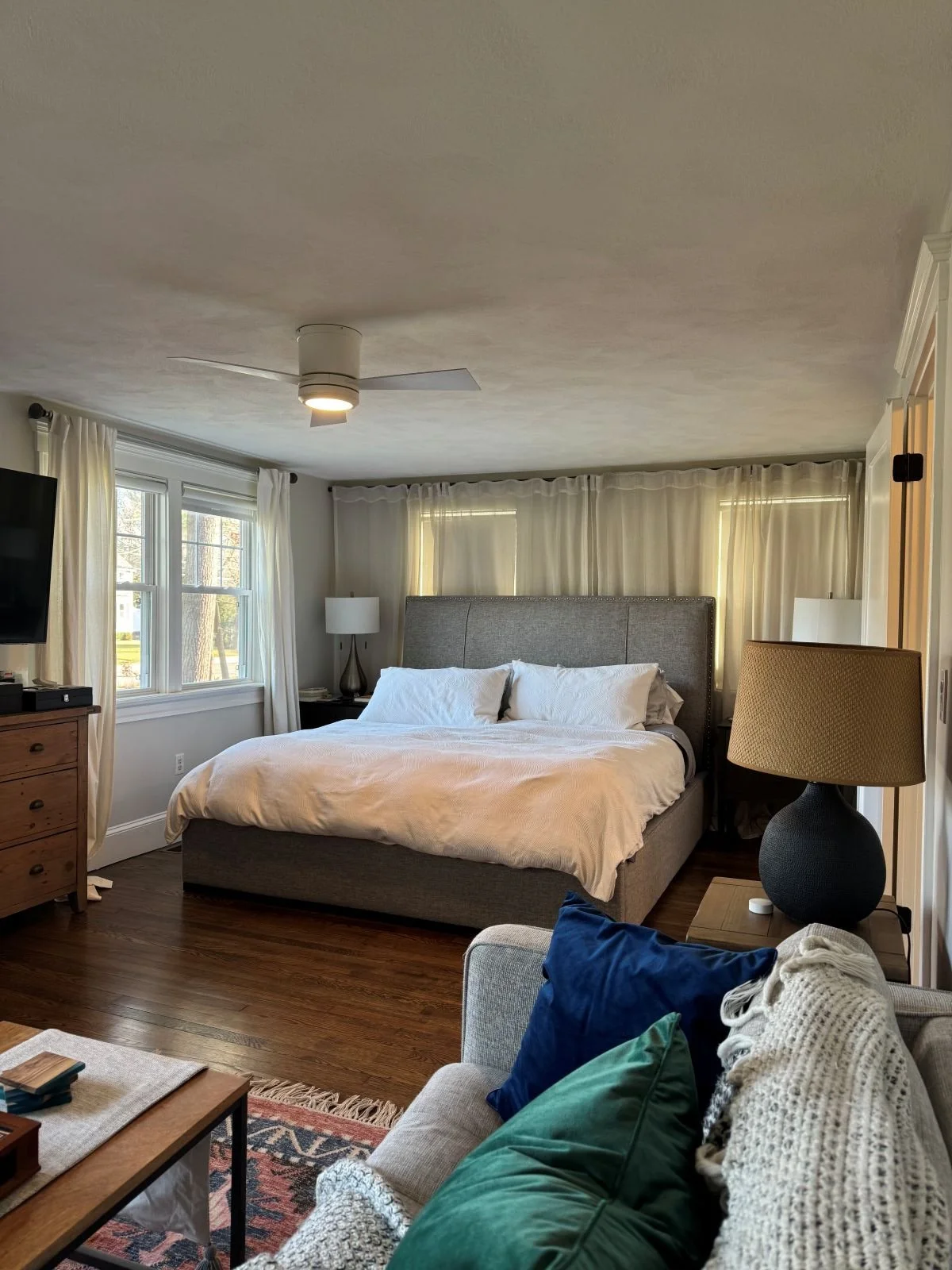 Existing primary bedroom of a Dutch Colonial home in Greater Boston prior to second story addition showing original bedroom layout and finishes before renovation by Tact and Grit Design Co.