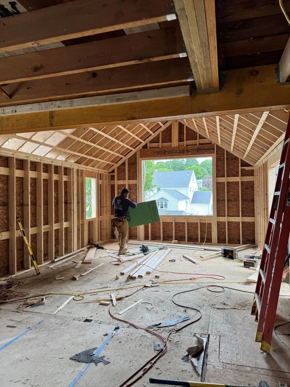Existing exterior wall removed showcasing the new view from the dining room into the vaulted kitchen addition.