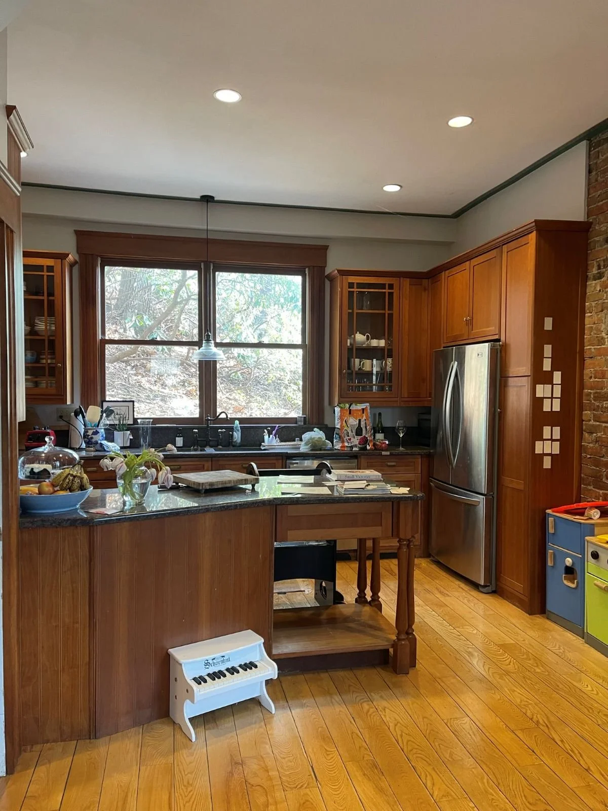 Existing kitchen of an 1846 Victorian home in Newton MA prior to renovation showing original dark wood cabinetry and layout before reconfiguration