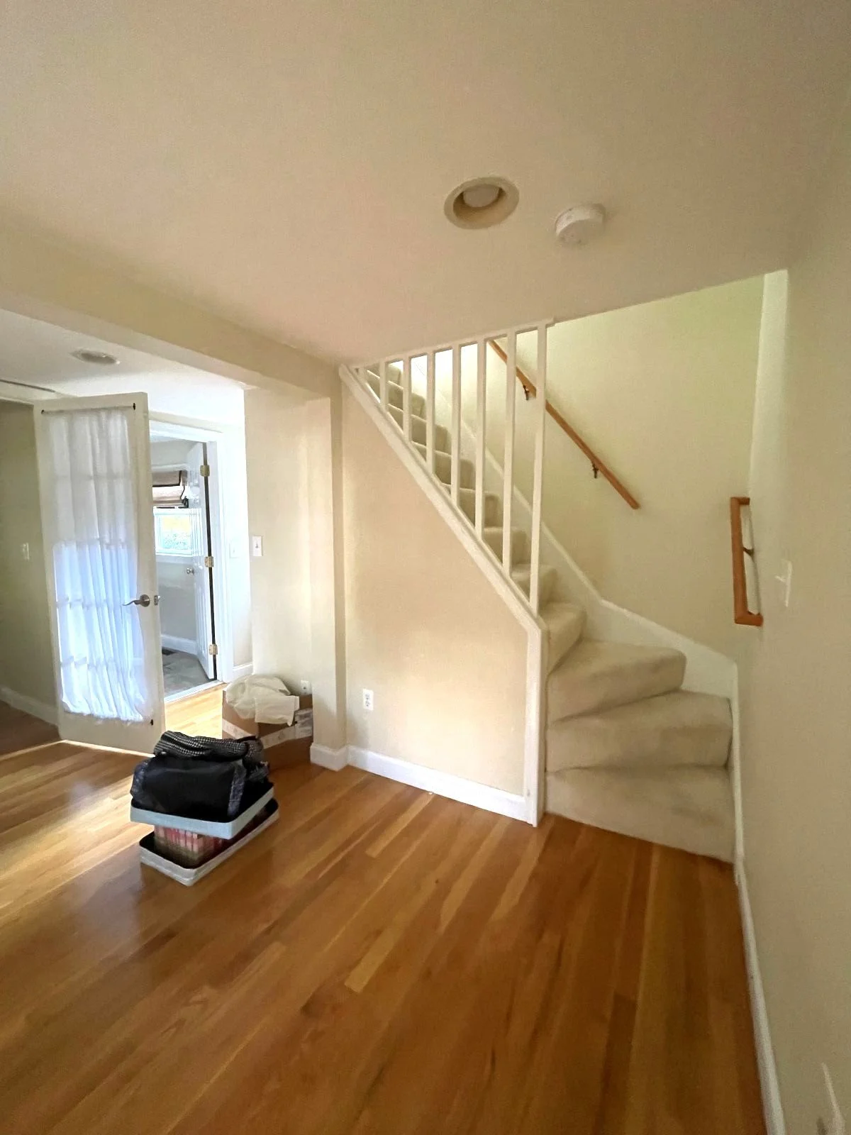 Secondary stair case prior to removal for new main level flow in Bedford colonial home.