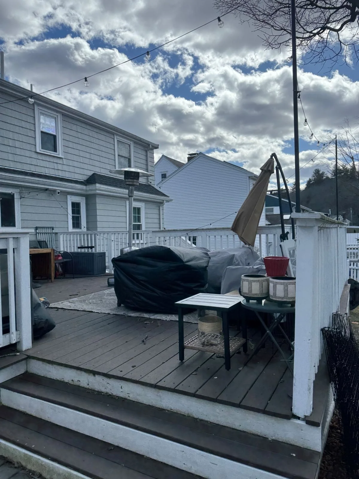 Existing deck and outdoor living area of a colonial home in Melrose, MA prior to rear addition and renovation.