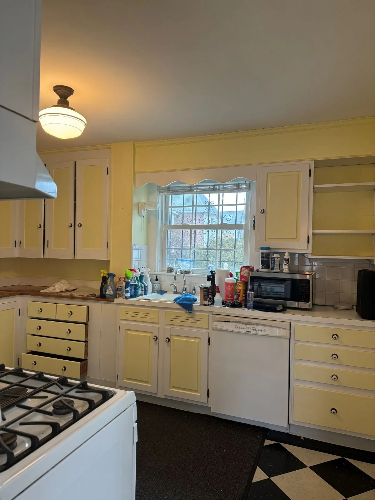 Interior view of the original dark and cramped kitchen in a Medford Dutch Colonial before it was moved into a light-filled addition.