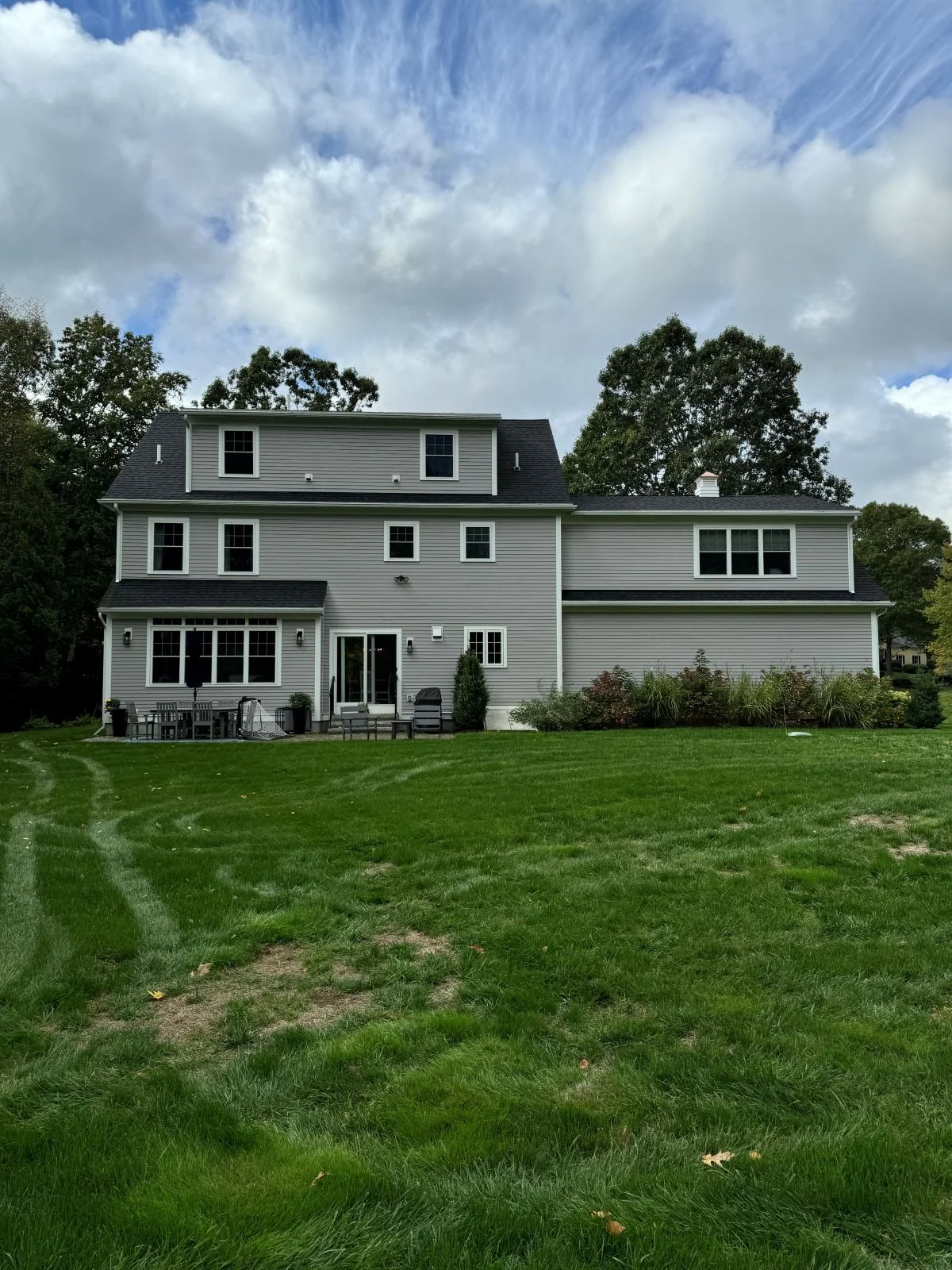 The rear exterior of a Hamilton MA home prior to the garage addition, deck and patio renovation.