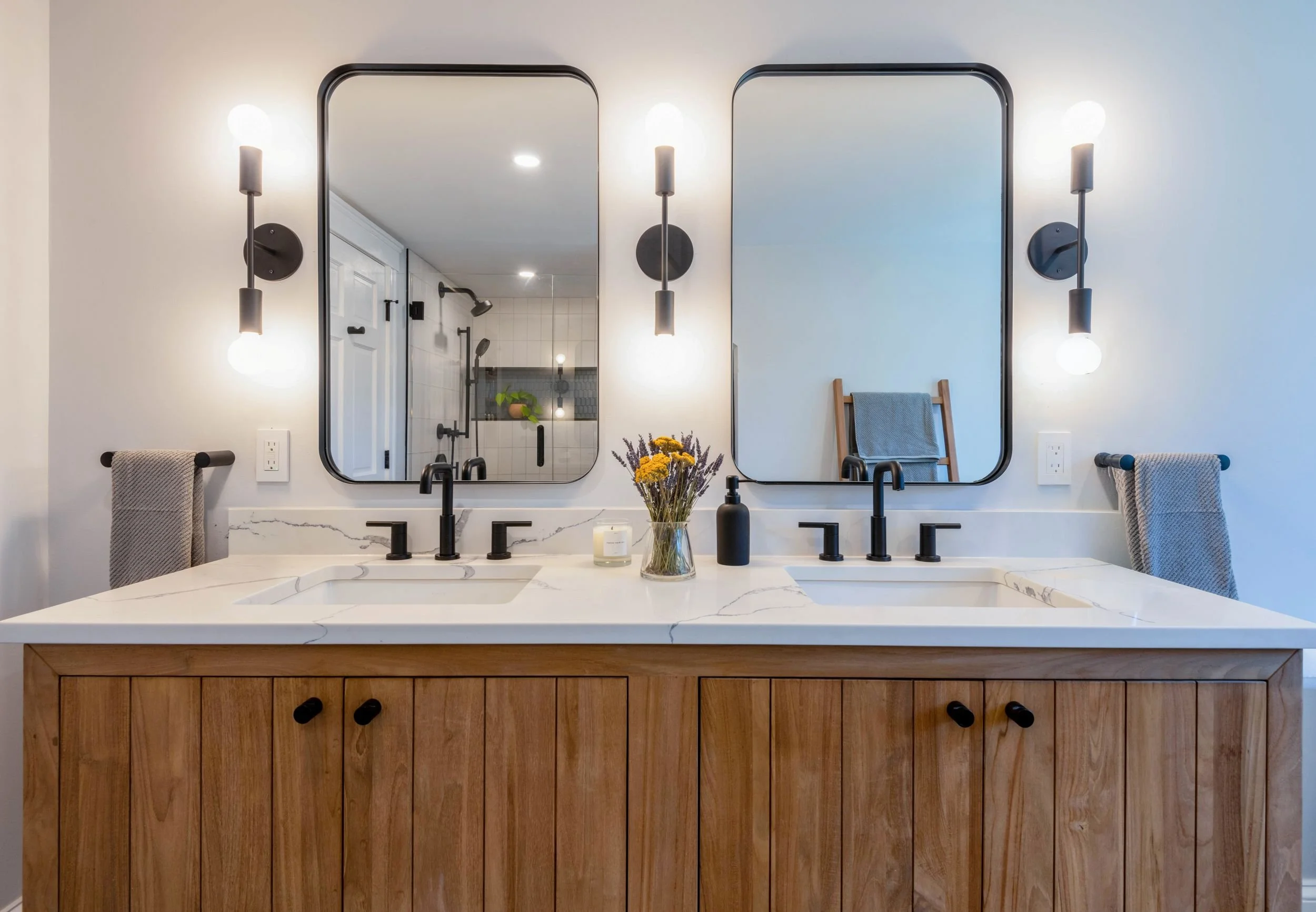 modern teak double sink vanity with black fixtures in primary bathroom in Medford, MA