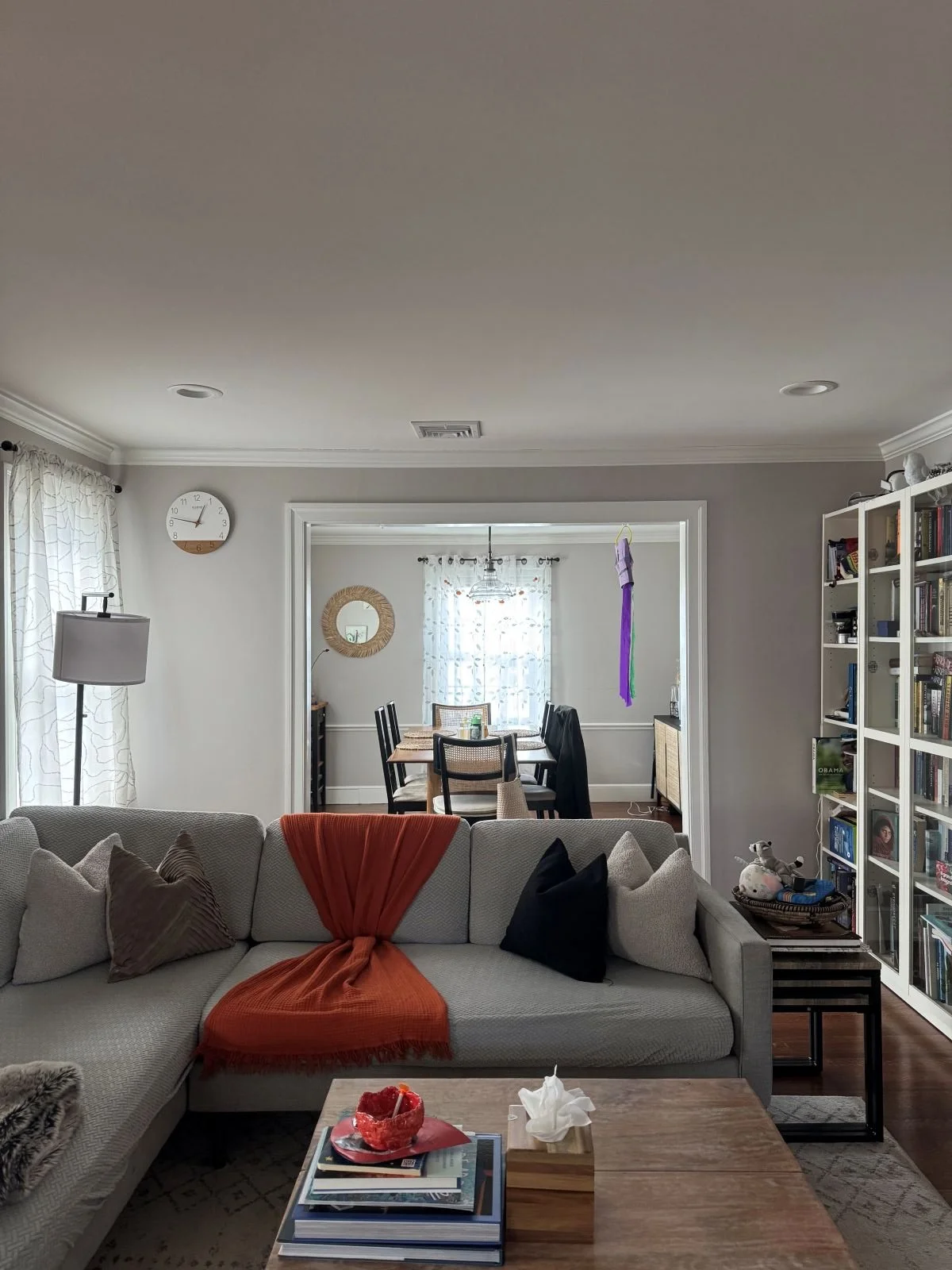 Dining room opening into a living room with sofa in existing floor plan