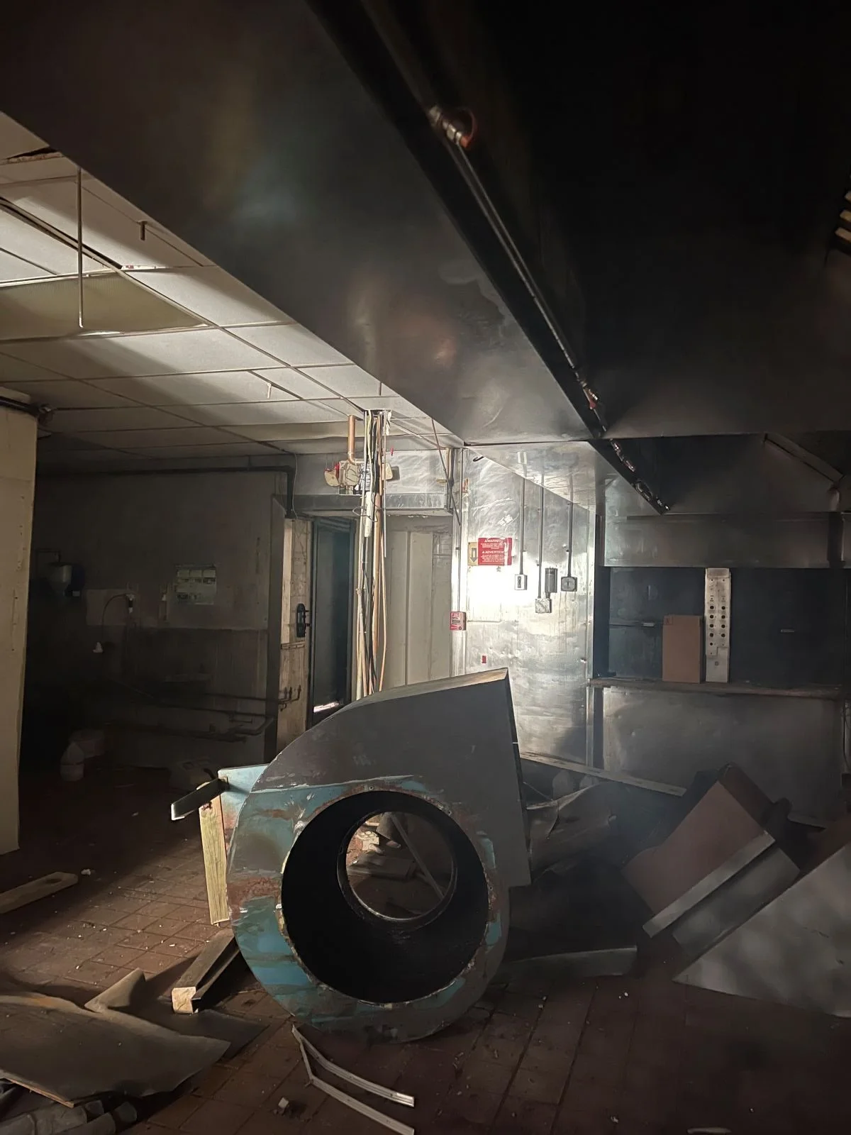 Exposed ductwork and deteriorated mechanical systems in an abandoned commercial kitchen in downtown Boston.