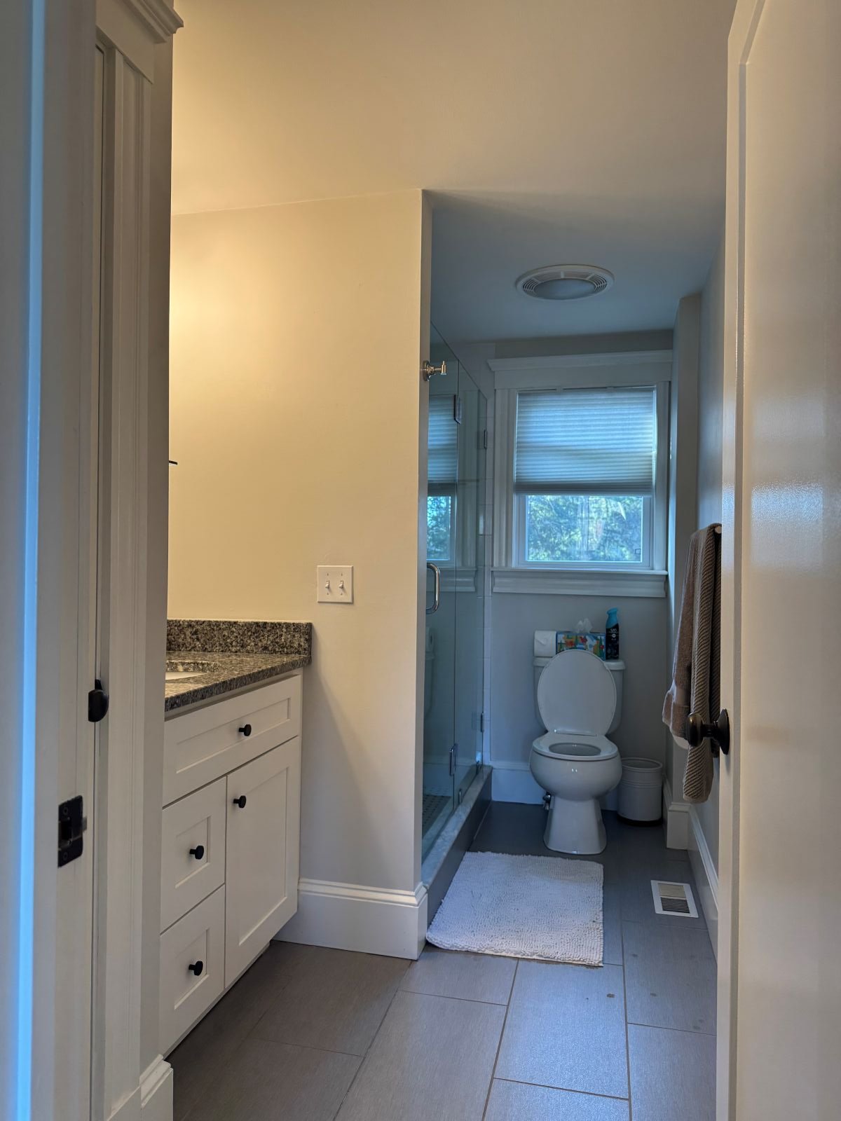 Existing primary bathroom of a Dutch Colonial home in Greater Boston prior to second story addition showing original vanity and tile finishes before renovation by Tact and Grit Design Co.