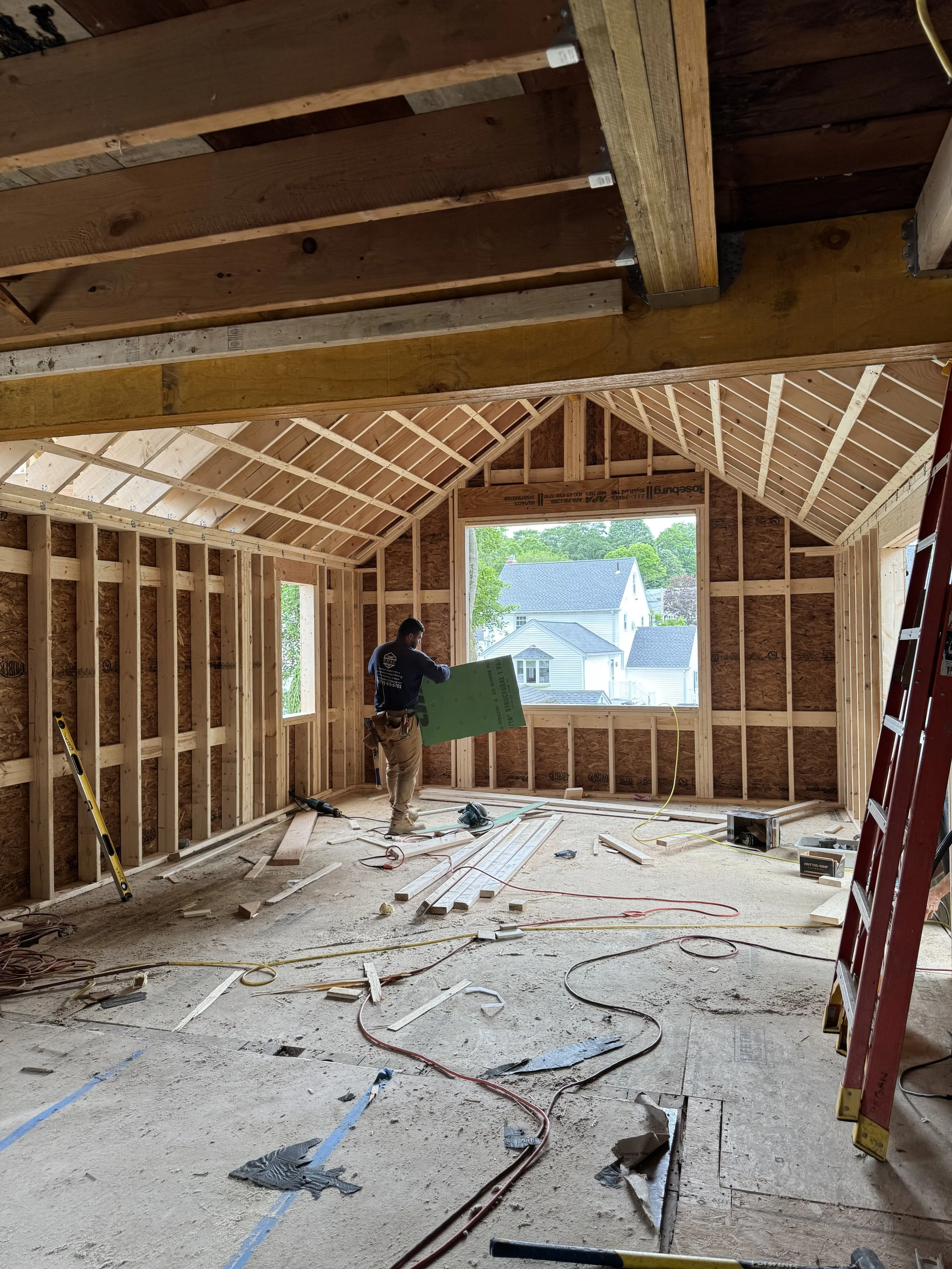 Spatial Transition: Existing exterior wall removed showcasing the new view from the dining room into the vaulted kitchen addition.