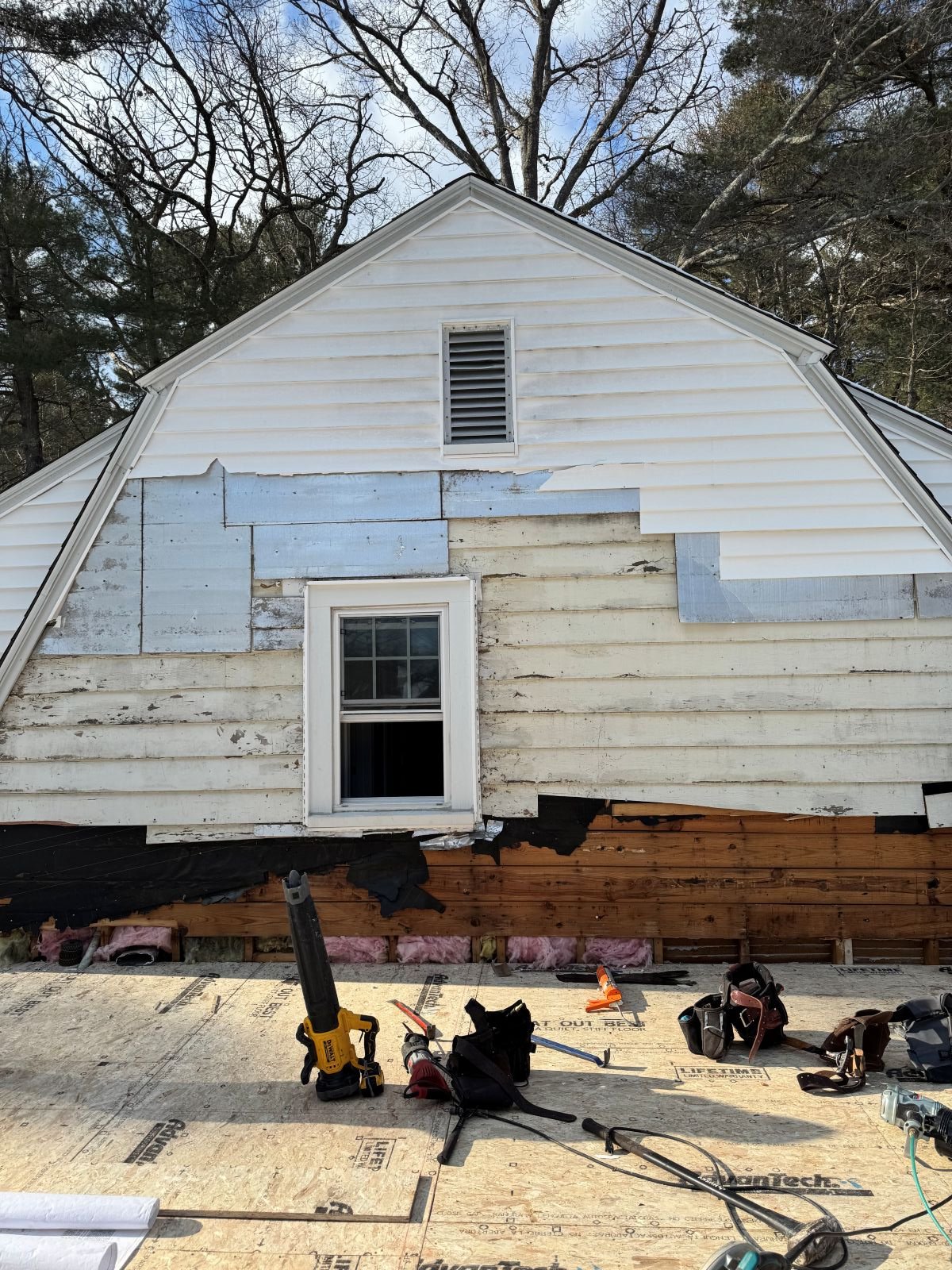 New second level floor framing meets existing side profile of gambrel roof line on a Dutch Colonial home in Greater Boston