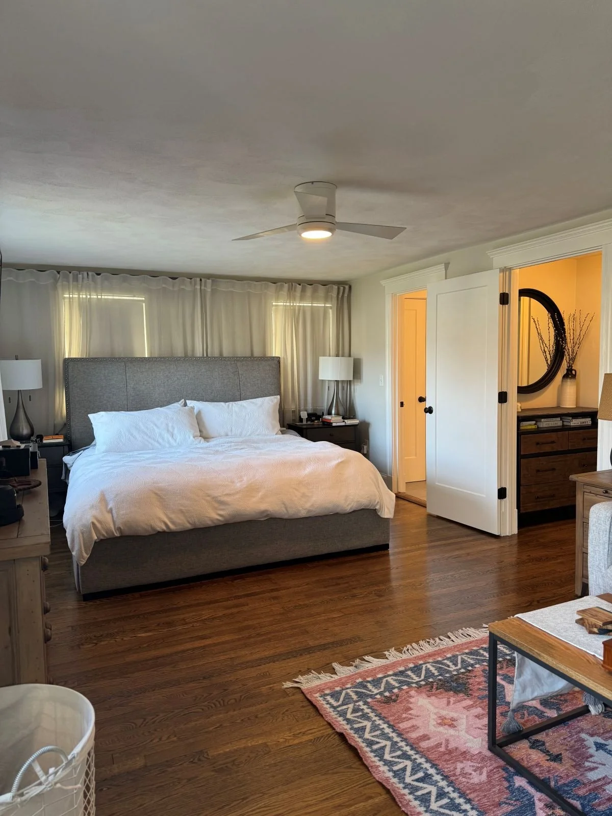 Existing ground level primary bedroom of a Dutch Colonial home in Greater Boston prior to second story addition showing original layout and finishes before renovation by Tact and Grit Design Co.