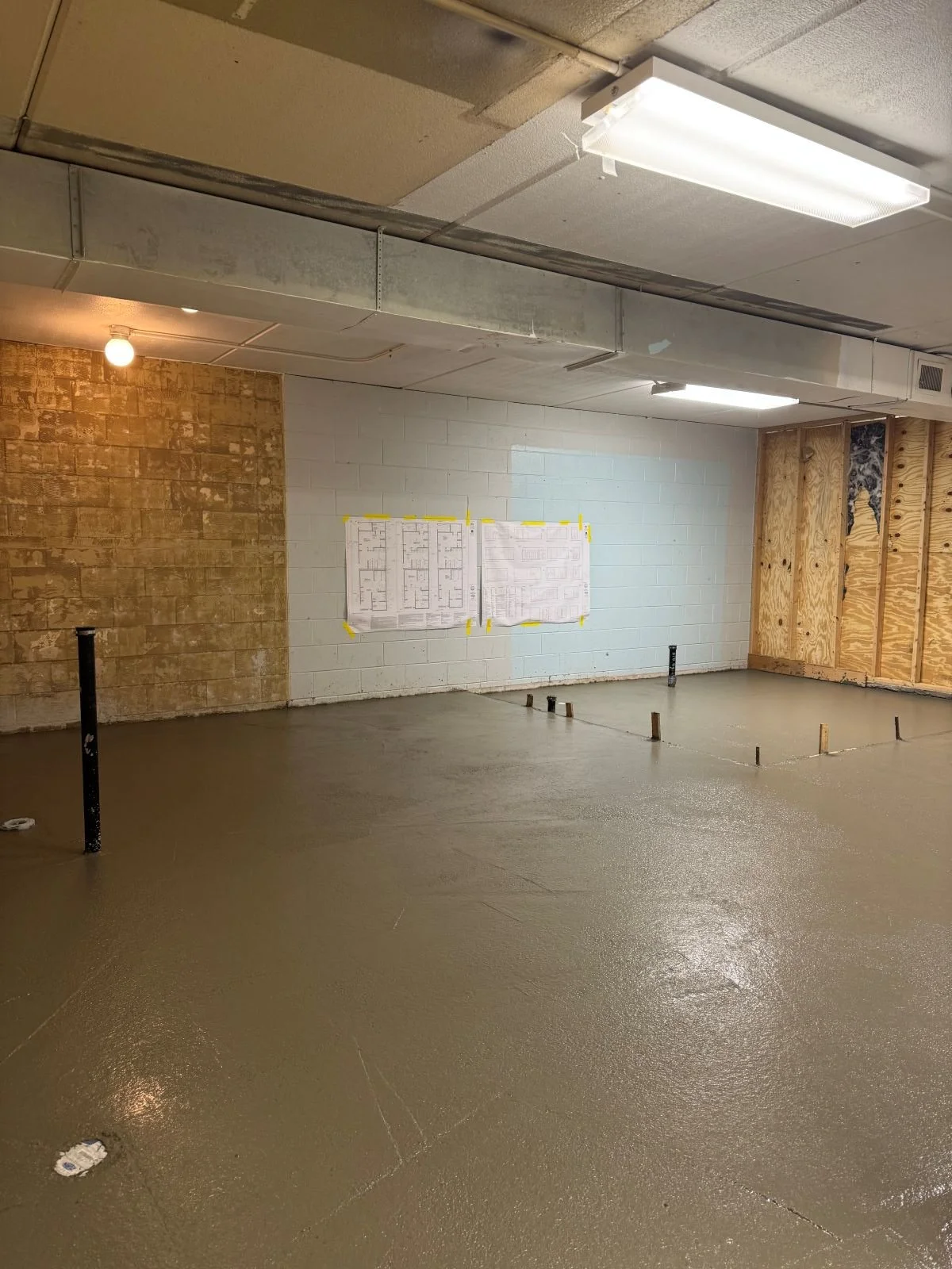New slab pour with stub ups for plumbing fixtures in reconfigured locker rooms