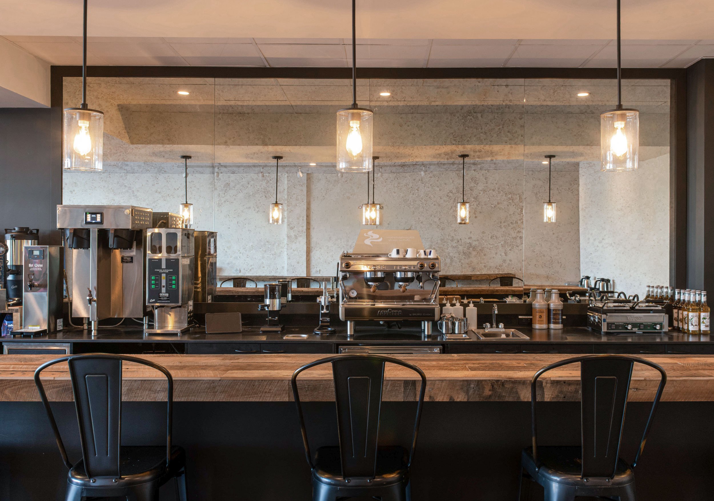 bar stools featured at custom coffee bar with rustic wood countertop