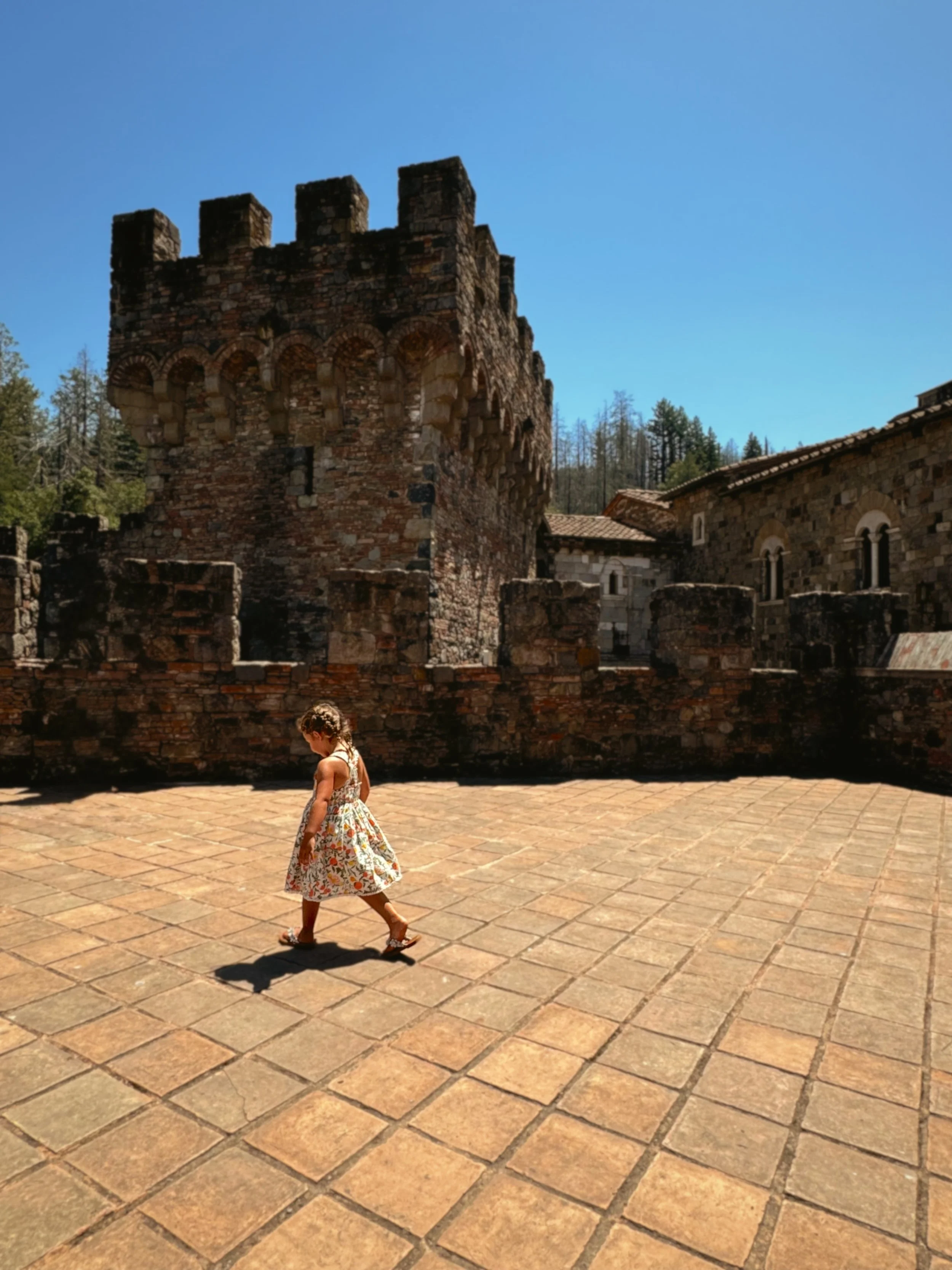 child walking through stone courtyard at Castello di Amorosa
