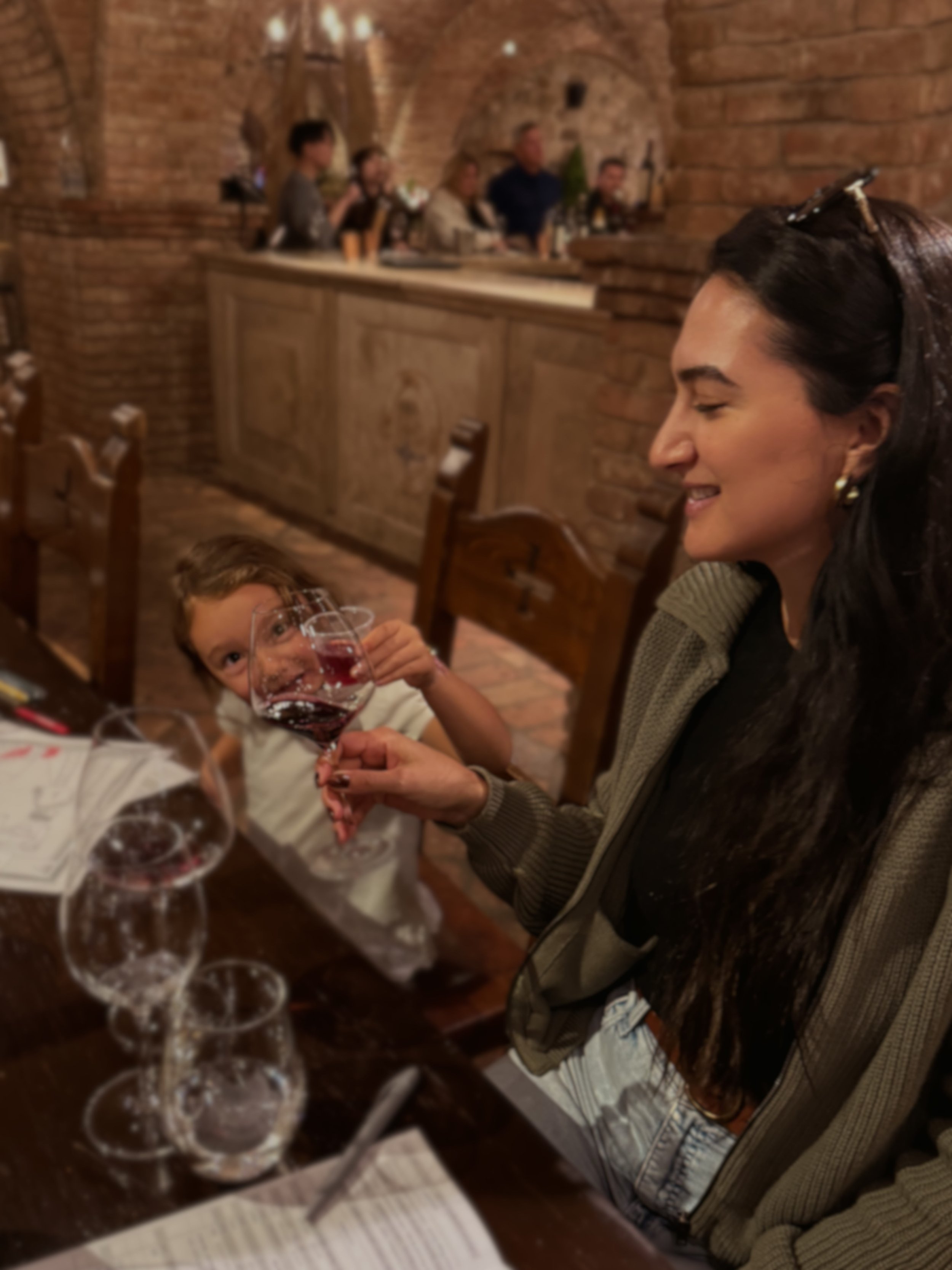 child cheers to wine tasting in a castle 
