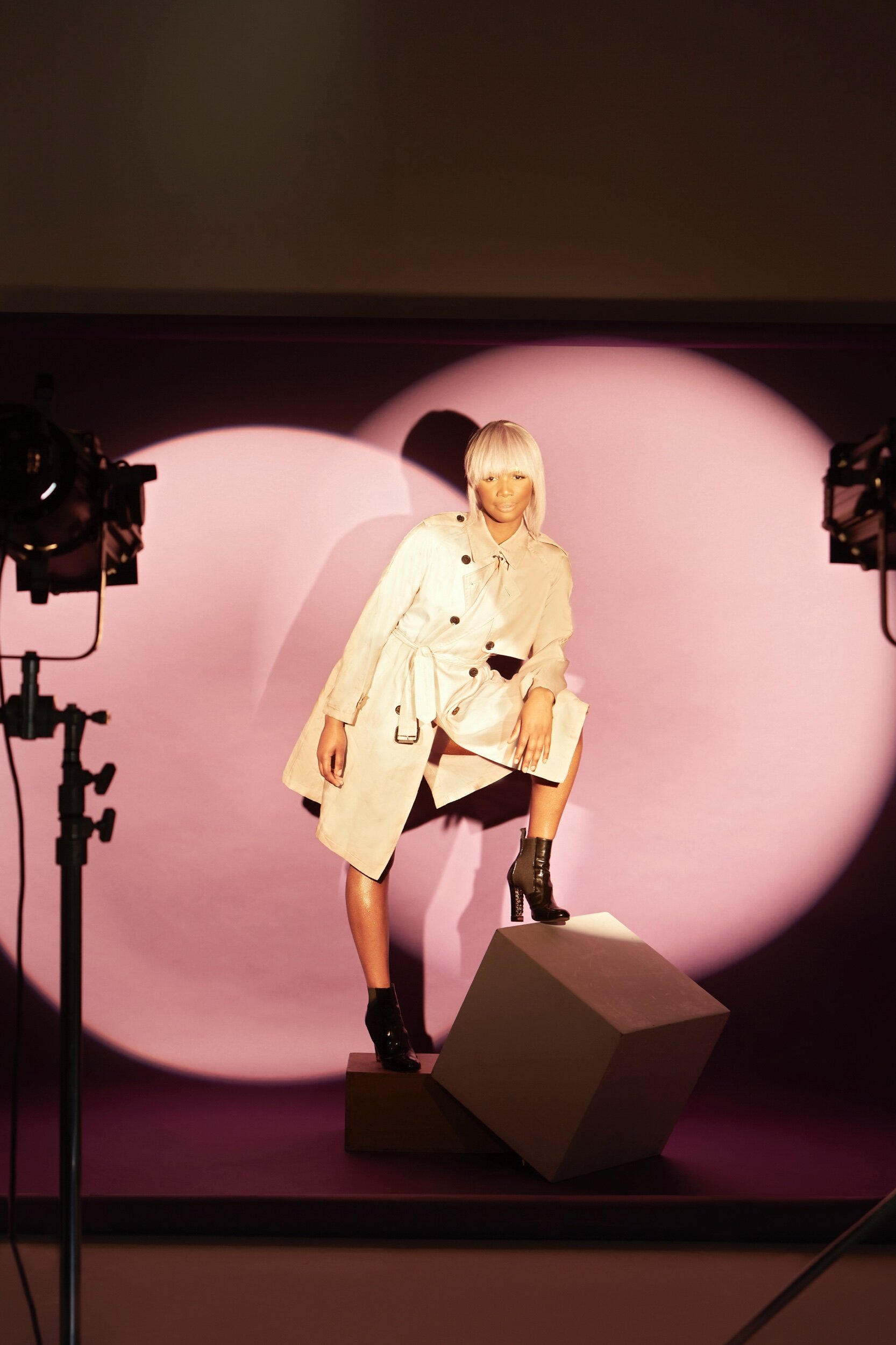 Presenter & Kiss FM DJ Henrie Kwushue wears Burberry coat and Chanel boots provided by My Wardrobe HQ