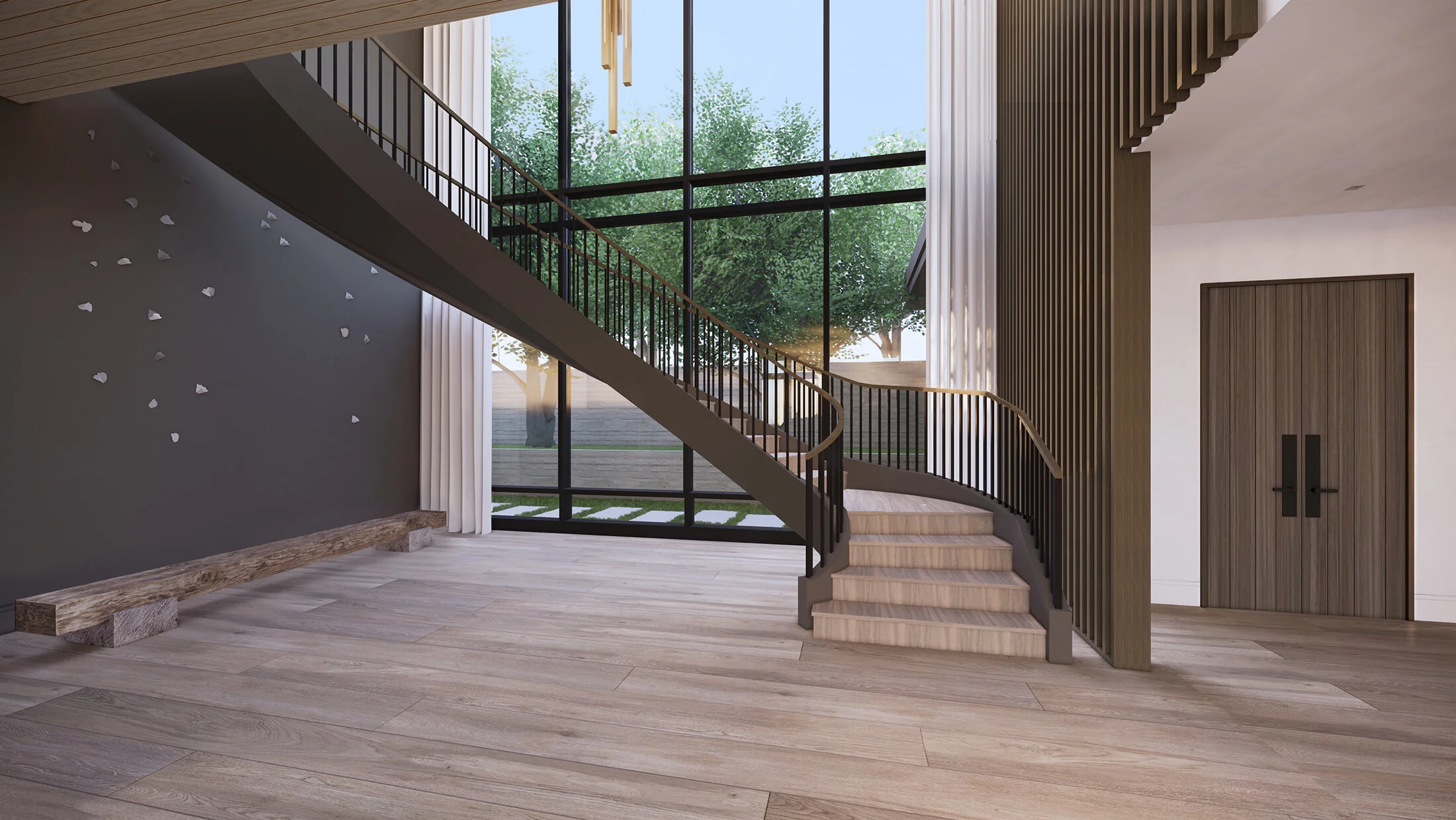 A view of the stairwell with a curvilinear wooden staircase with a metal rail