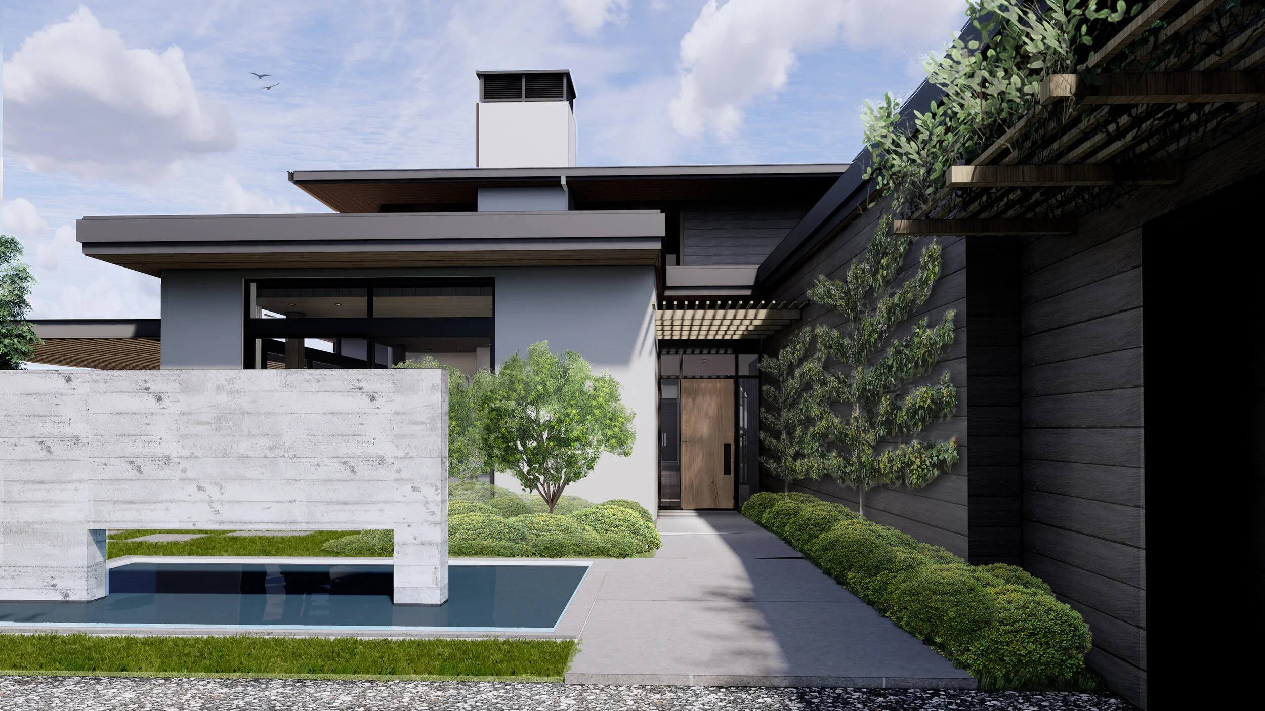 A view of the front elevation of the house with a concrete water feature, paved walkway and shrubs