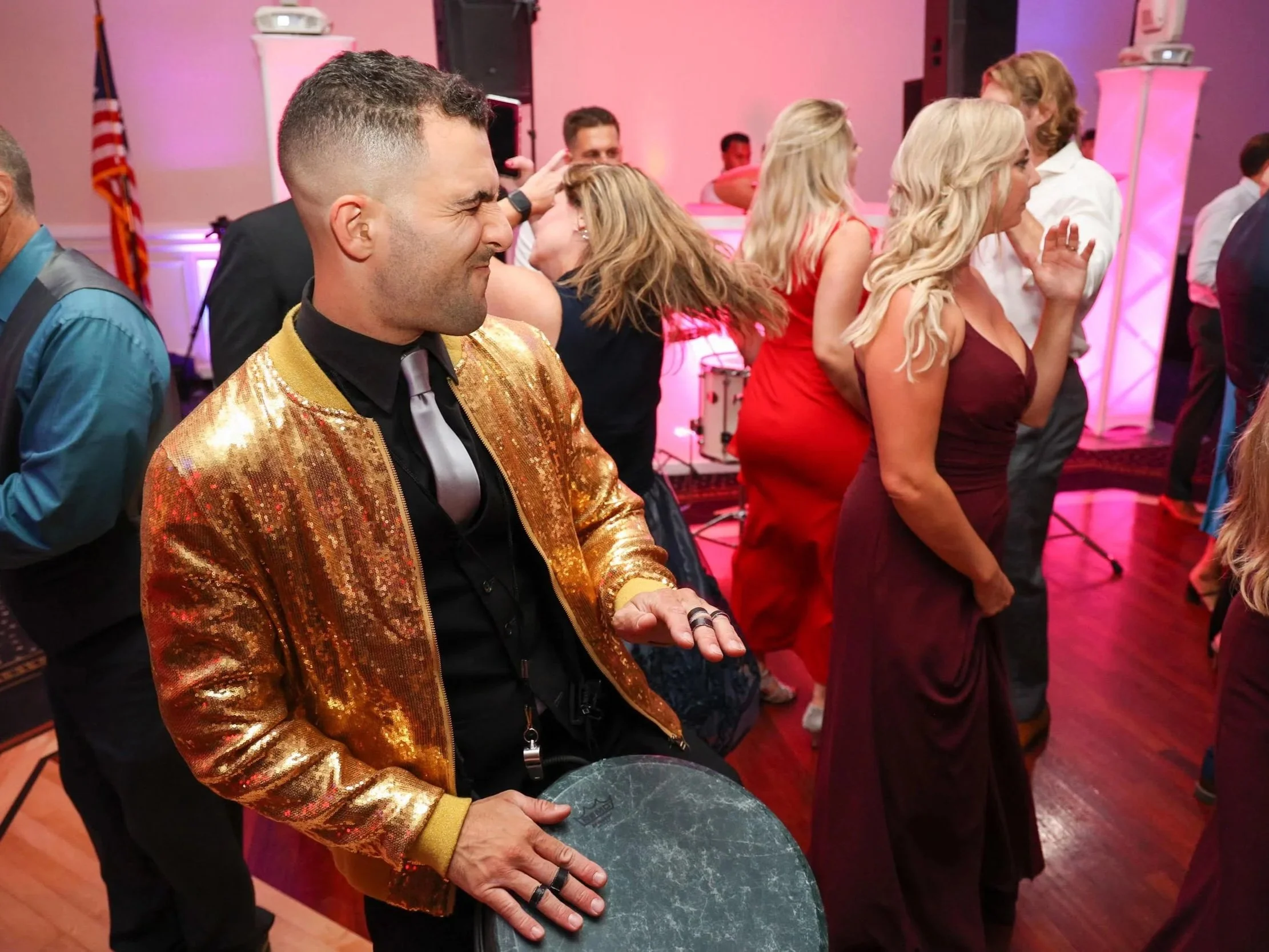 high class wedding event entertainment drummer is wearing gold sequins and playing world class drums