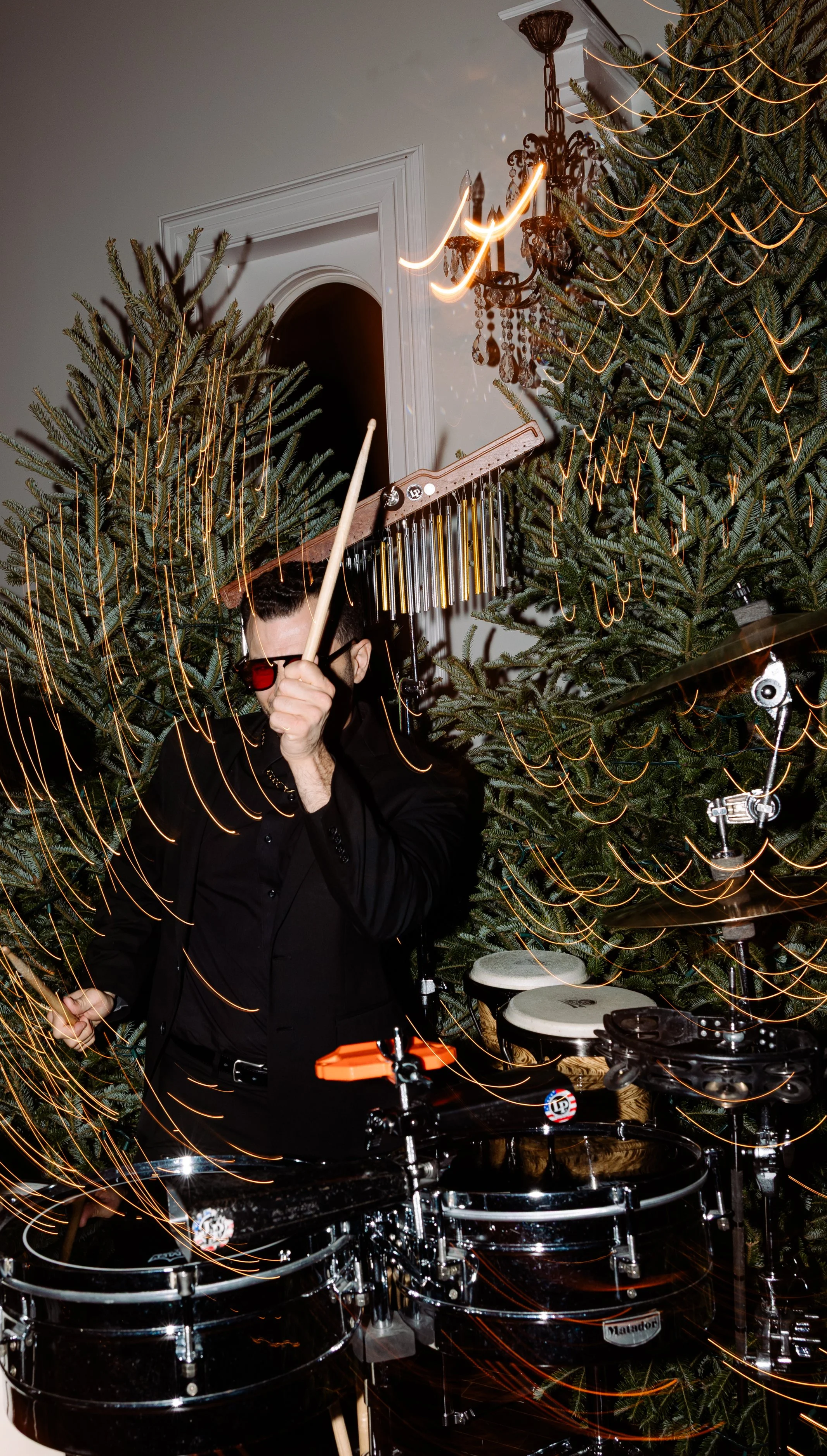 Wedding Musician plays percussion with cool lighting at christmas themed wedding