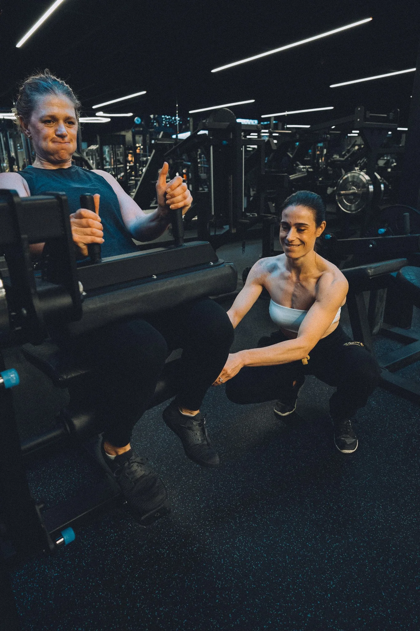 Erika Vig coaching a client through a seated machine exercise at The Lab Gym in San Ramon