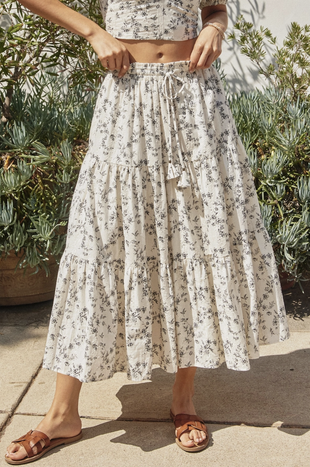 Model wearing a matching floral top and skirt set