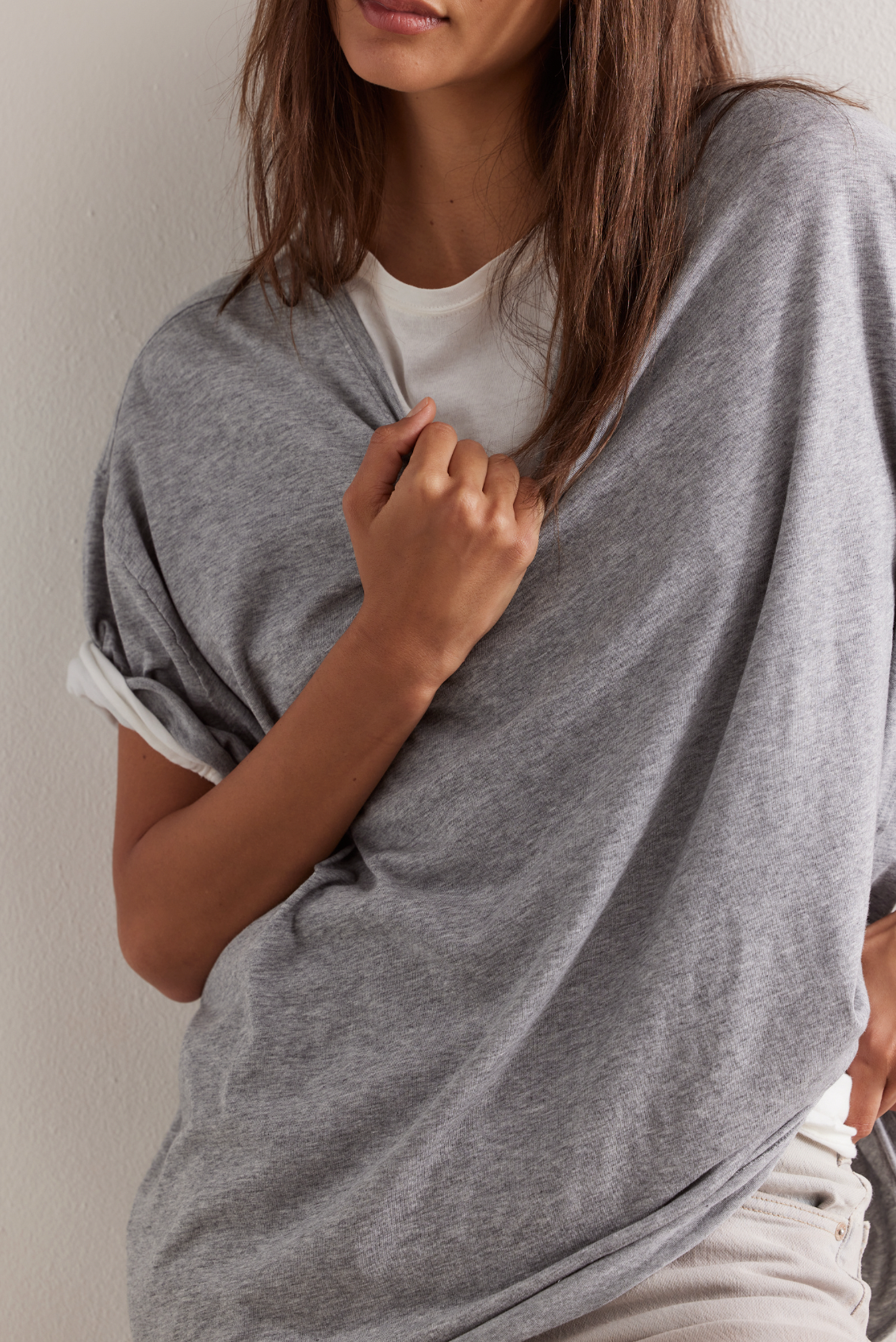 Model is wearing a heather gray T-shirt by Free people