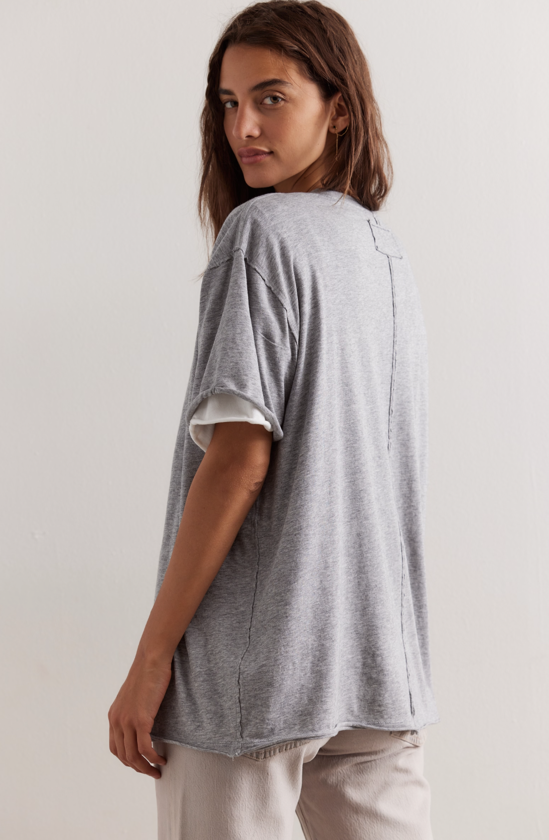 Model is wearing a heather gray T-shirt by Free people