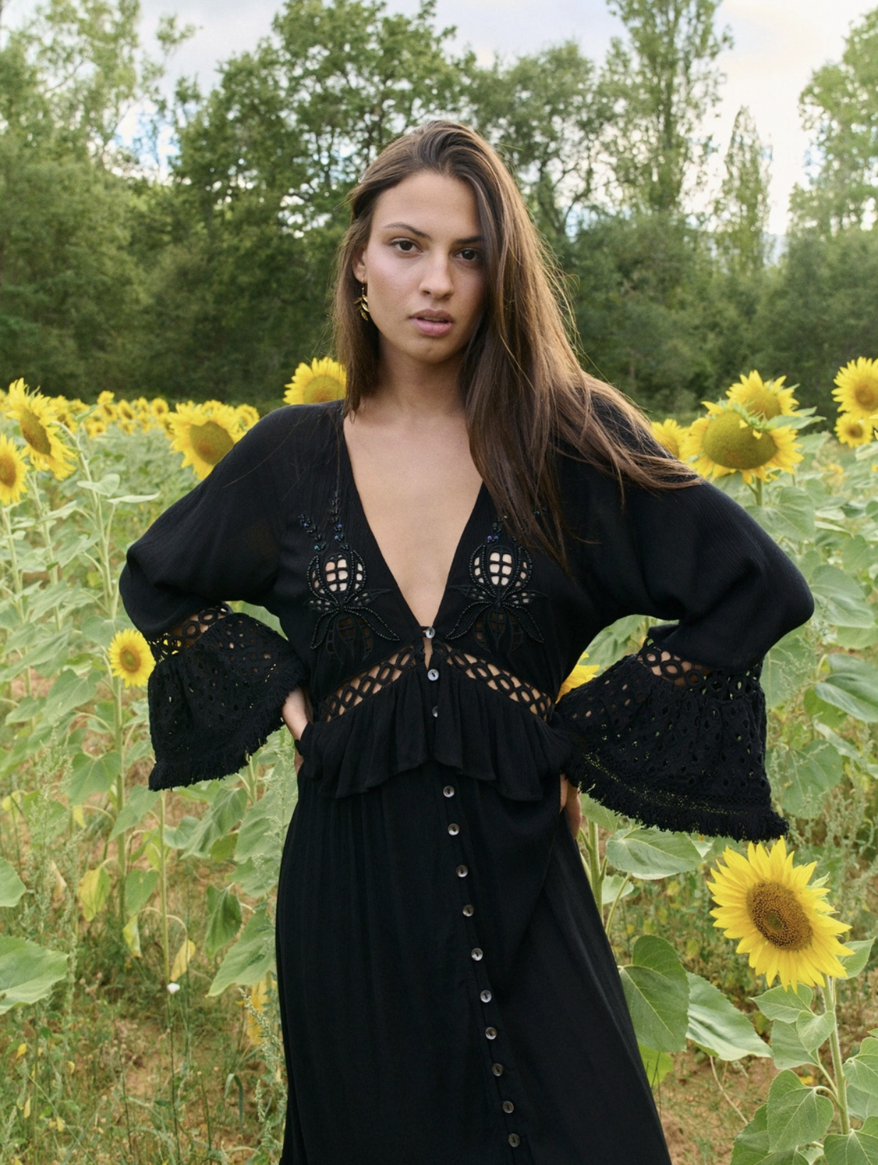 model wearing embellished black maxi dress