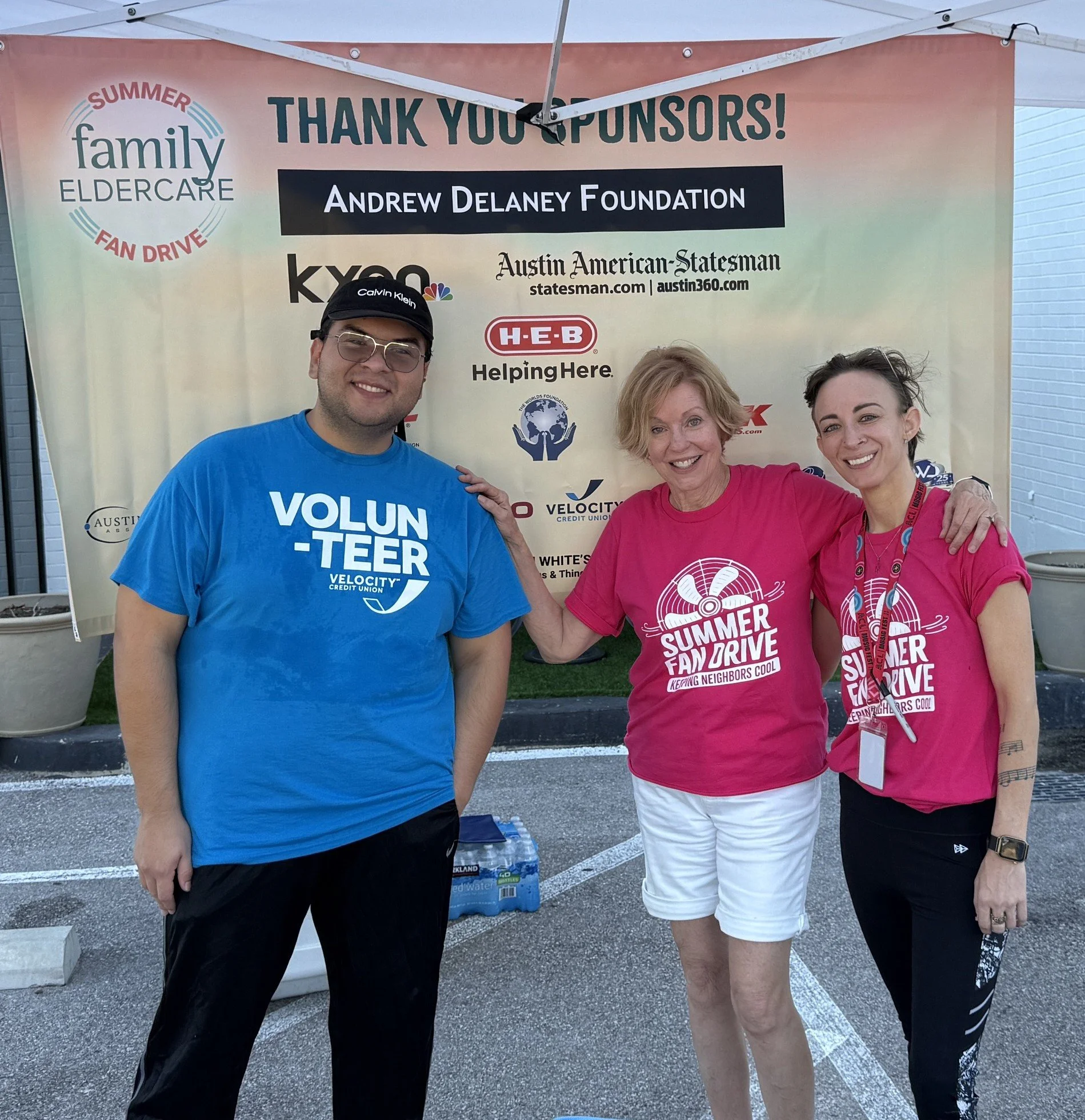 3 people standing in front of a thank you sponsors sign
