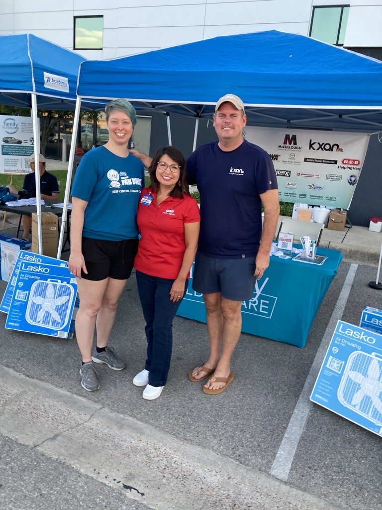 3 people standing under a tent