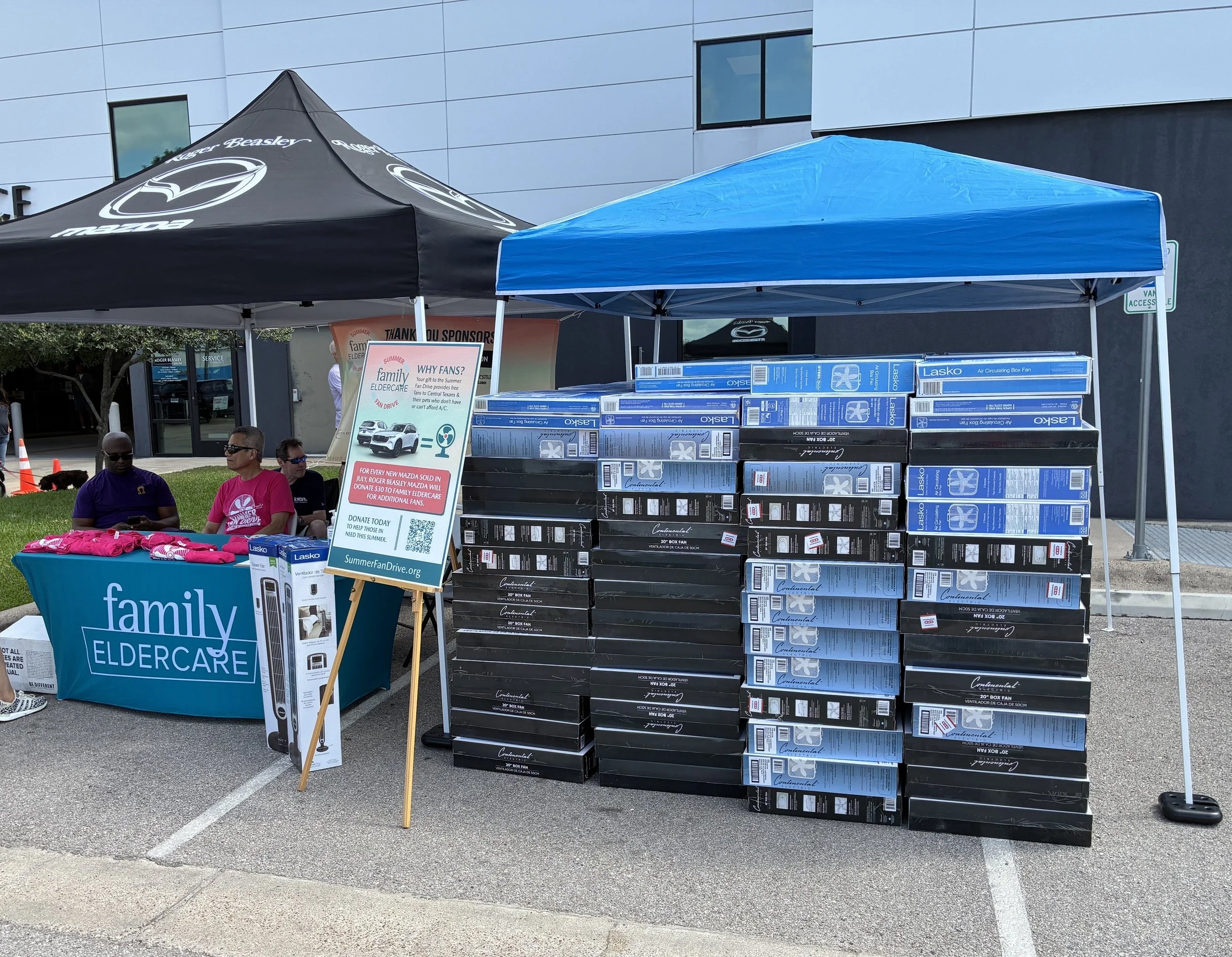 stacks of box fans under a tent